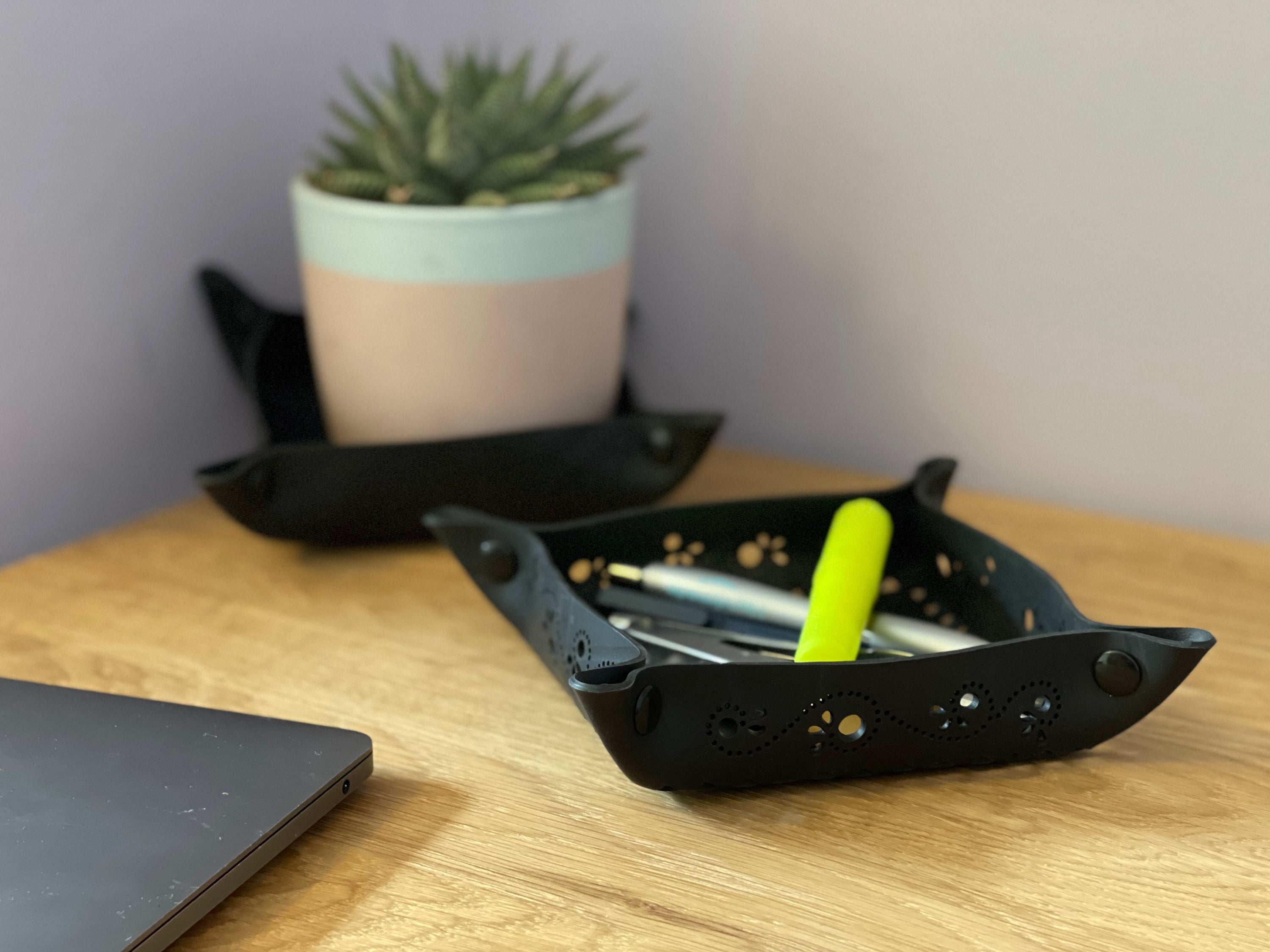 A handcrafted Upcycled Rubber Trinket Tray made from recycled tyre inner tubes, featuring a unique design and press-stud corners for versatility.