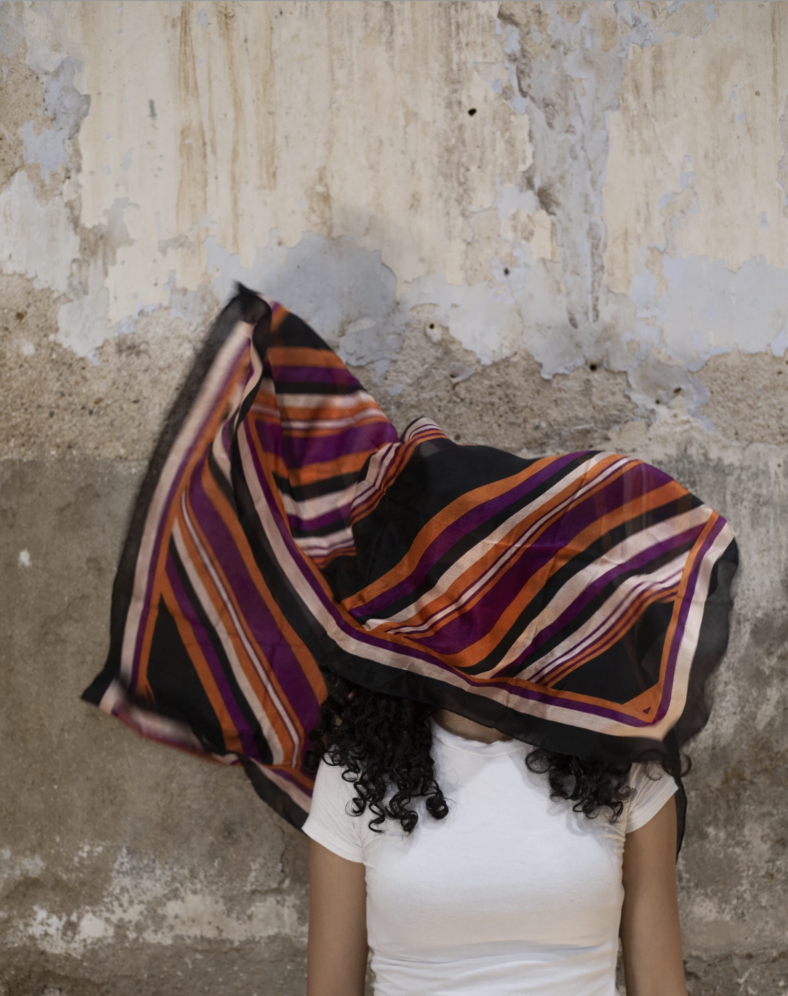 A vibrant upcycled silk head and face mask scarf showcasing unique patterns and colors, perfect for eco-friendly fashion enthusiasts.