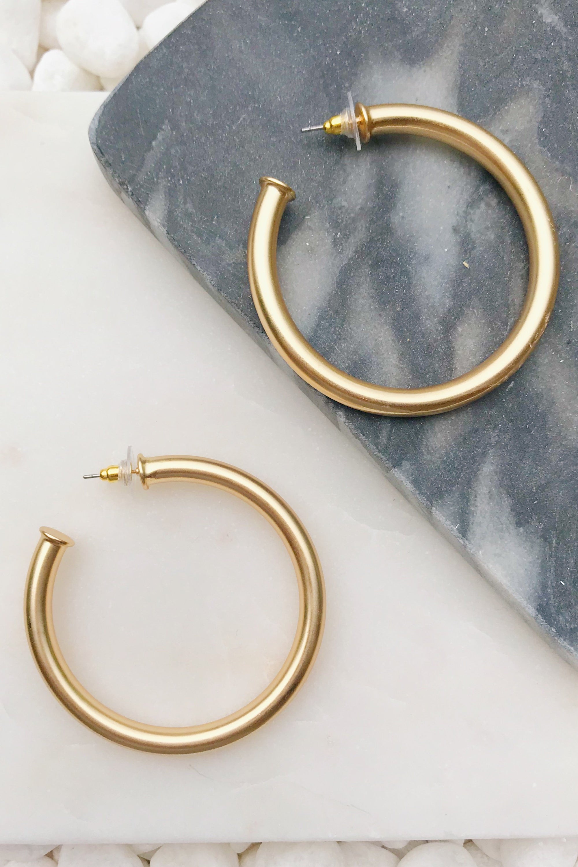 Upper Class Taste Hoop Earrings in matte gold finish, featuring a lightweight tube design with a 2-inch diameter.