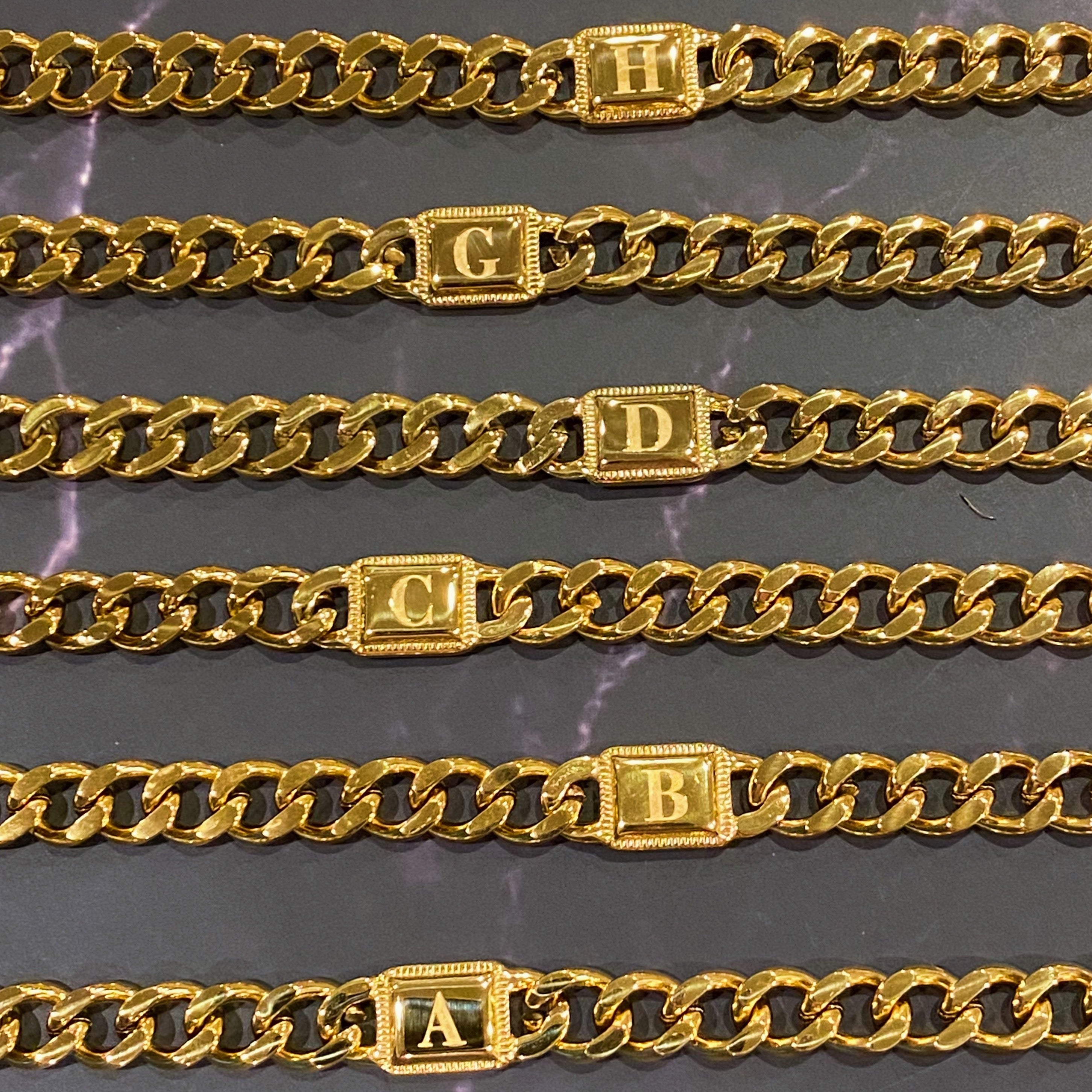 Uptown Cuban Chain Initial Bracelet featuring a personalized engraved initial tag, crafted from 18k gold plated stainless steel.