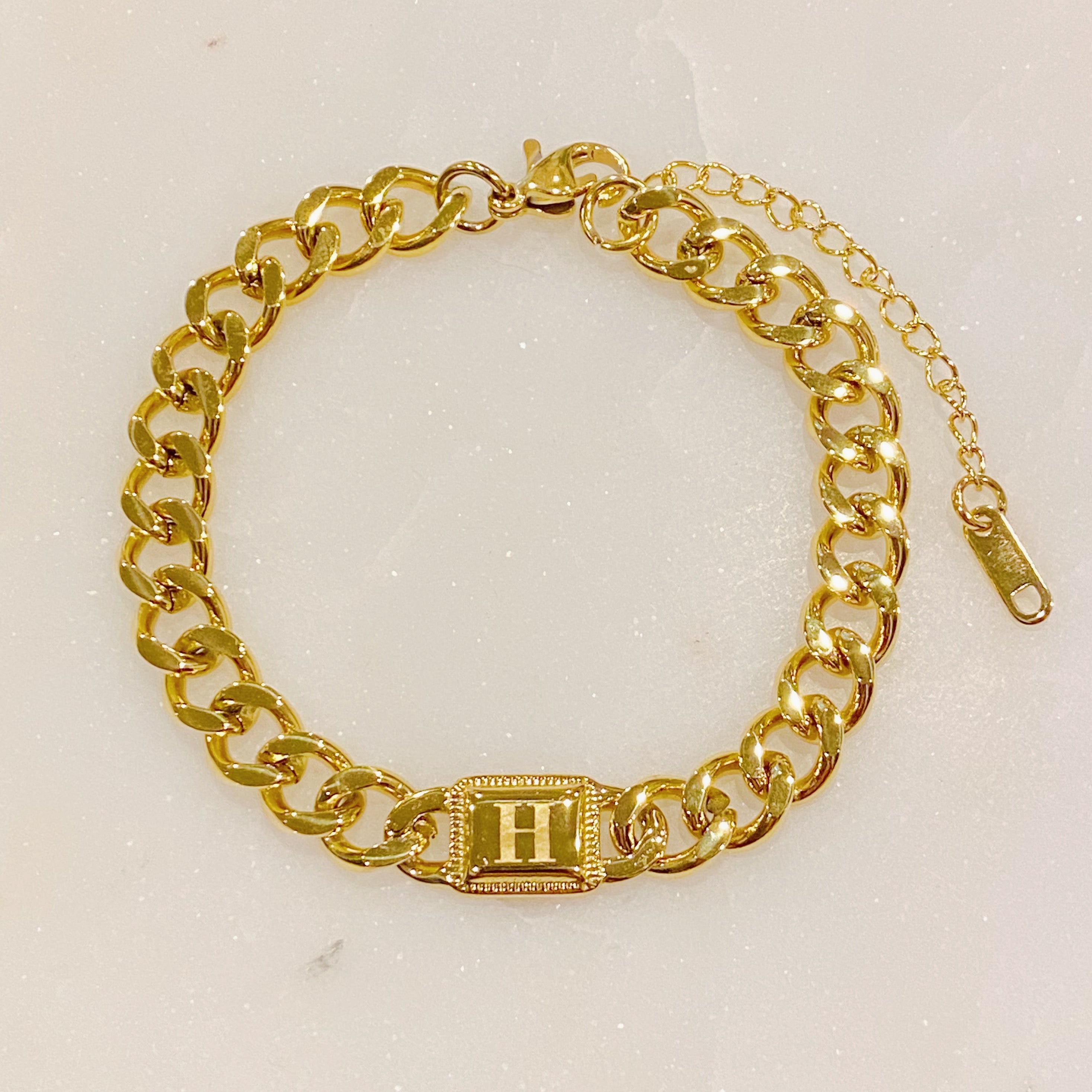 Uptown Cuban Chain Initial Bracelet featuring a personalized engraved initial tag, crafted from 18k gold plated stainless steel.