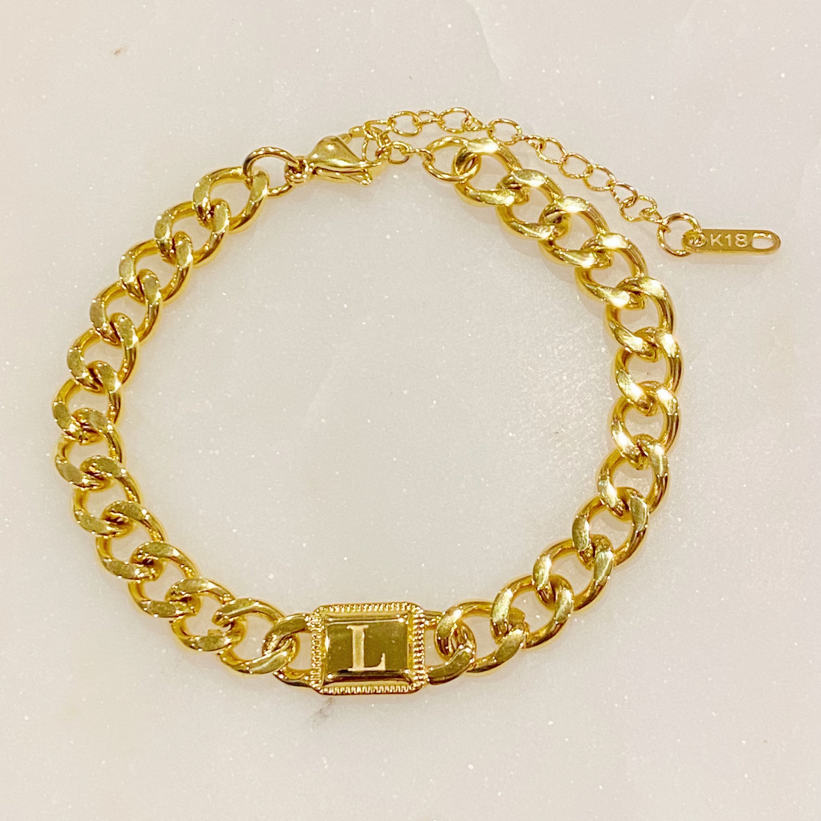 Uptown Cuban Chain Initial Bracelet featuring a personalized engraved initial tag, crafted from 18k gold plated stainless steel.