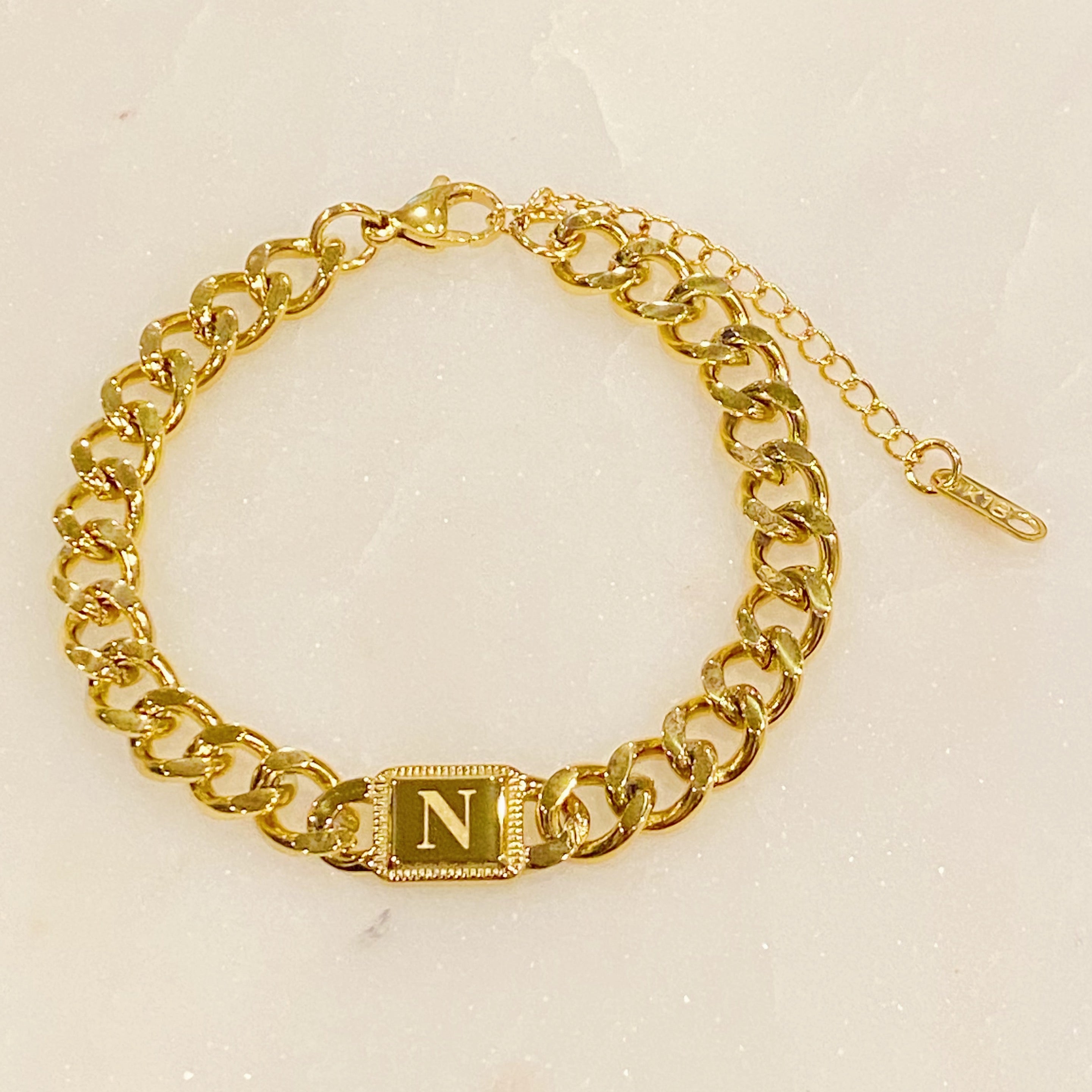 Uptown Cuban Chain Initial Bracelet featuring a personalized engraved initial tag, crafted from 18k gold plated stainless steel.