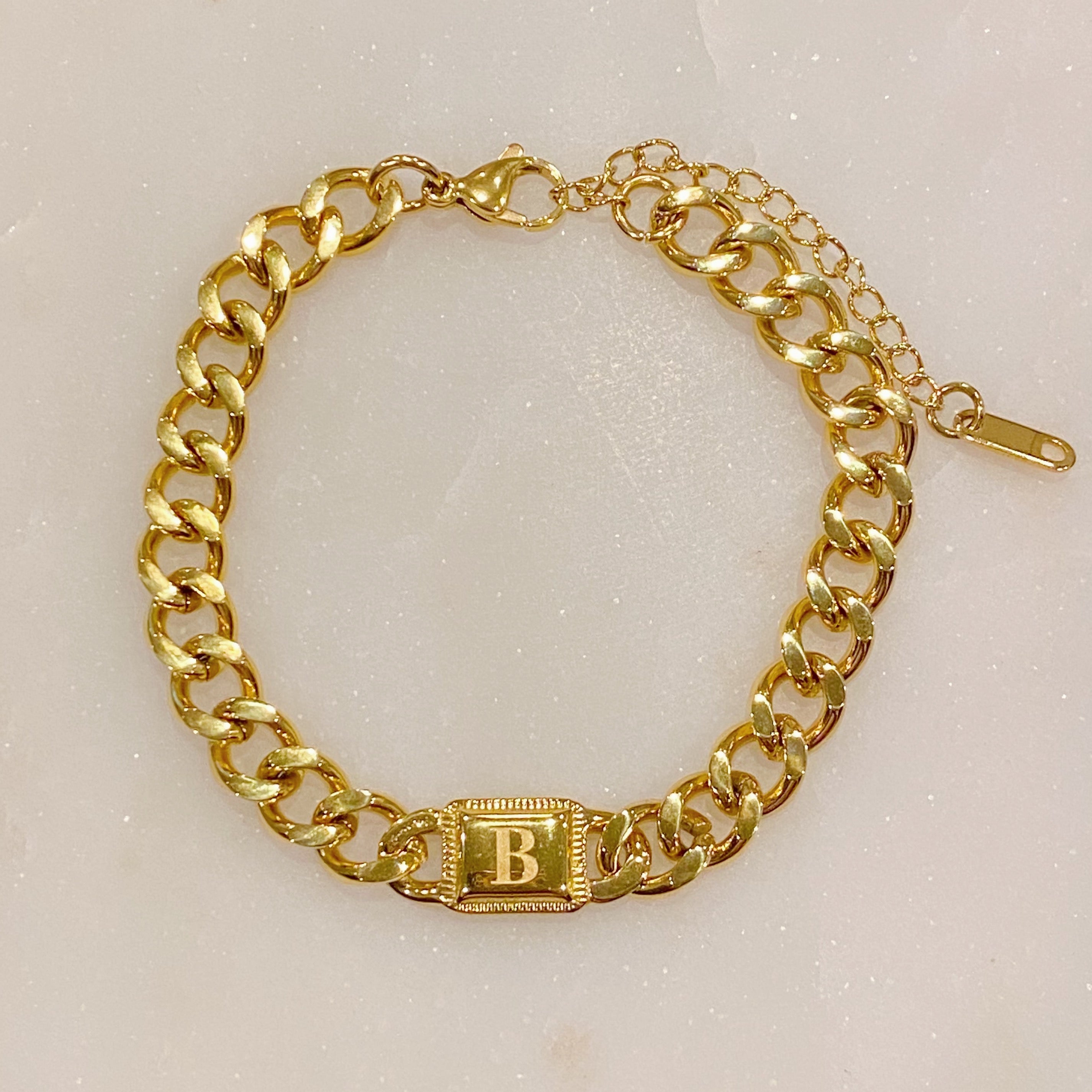 Uptown Cuban Chain Initial Bracelet featuring a personalized engraved initial tag, crafted from 18k gold plated stainless steel.