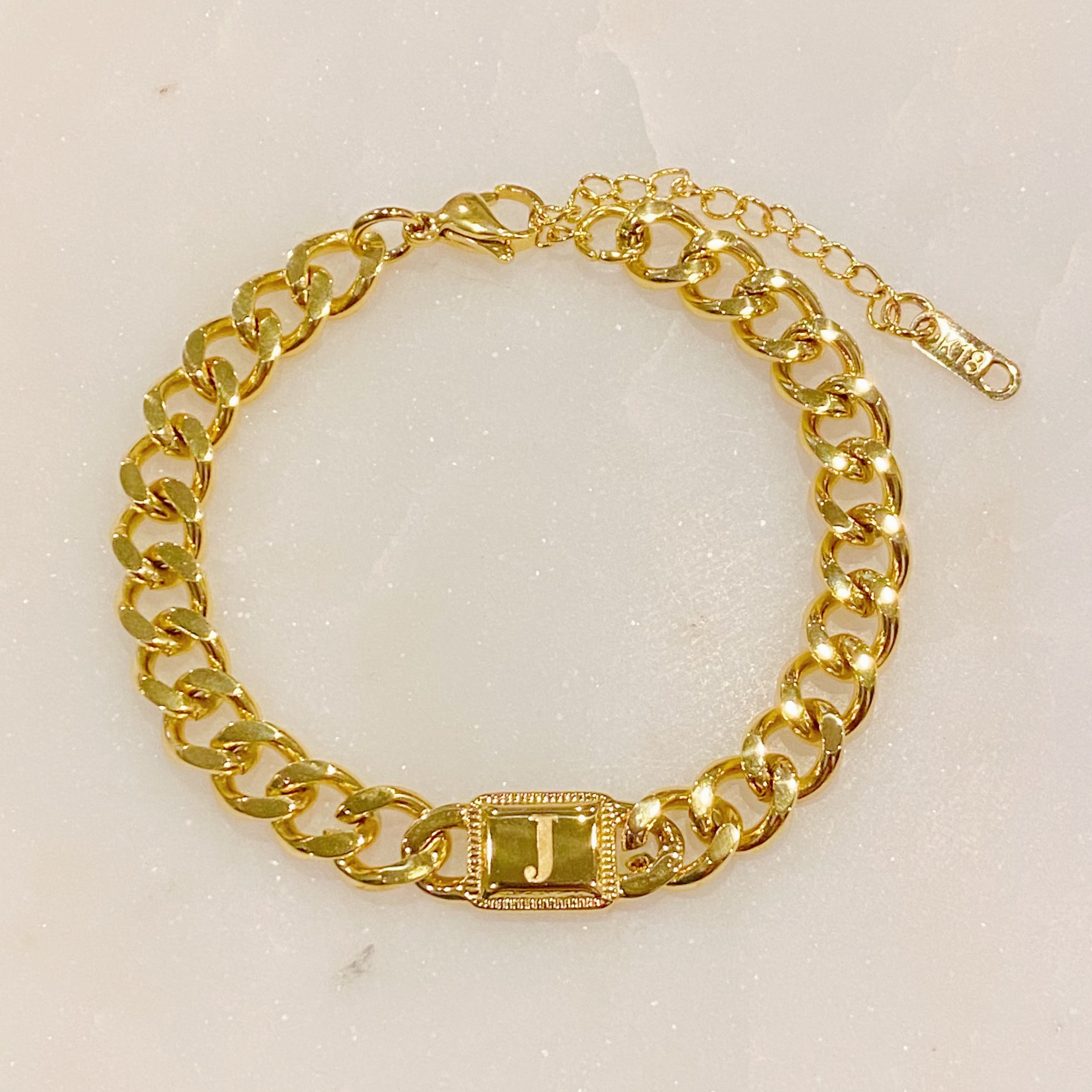 Uptown Cuban Chain Initial Bracelet featuring a personalized engraved initial tag, crafted from 18k gold plated stainless steel.