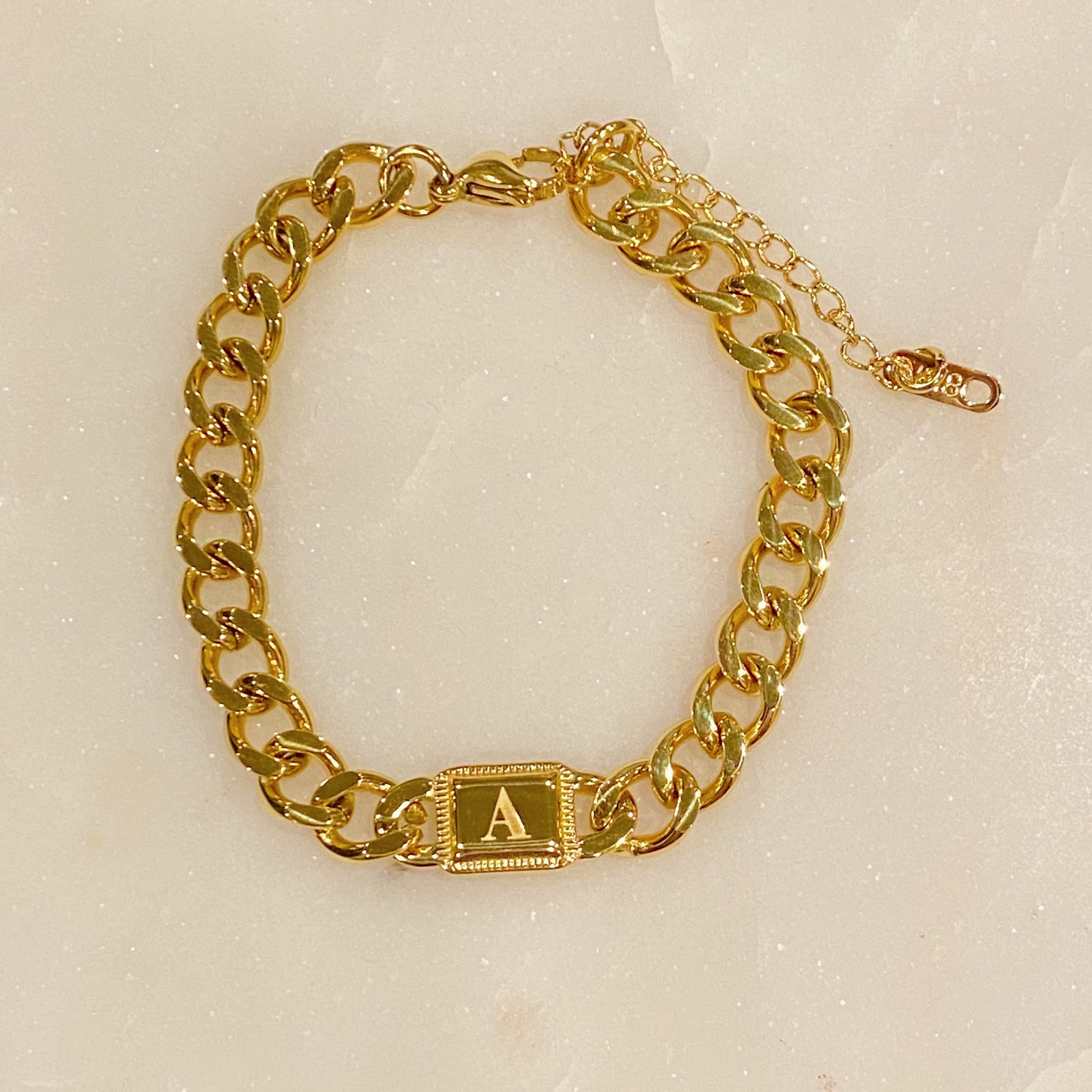 Uptown Cuban Chain Initial Bracelet featuring a personalized engraved initial tag, crafted from 18k gold plated stainless steel.