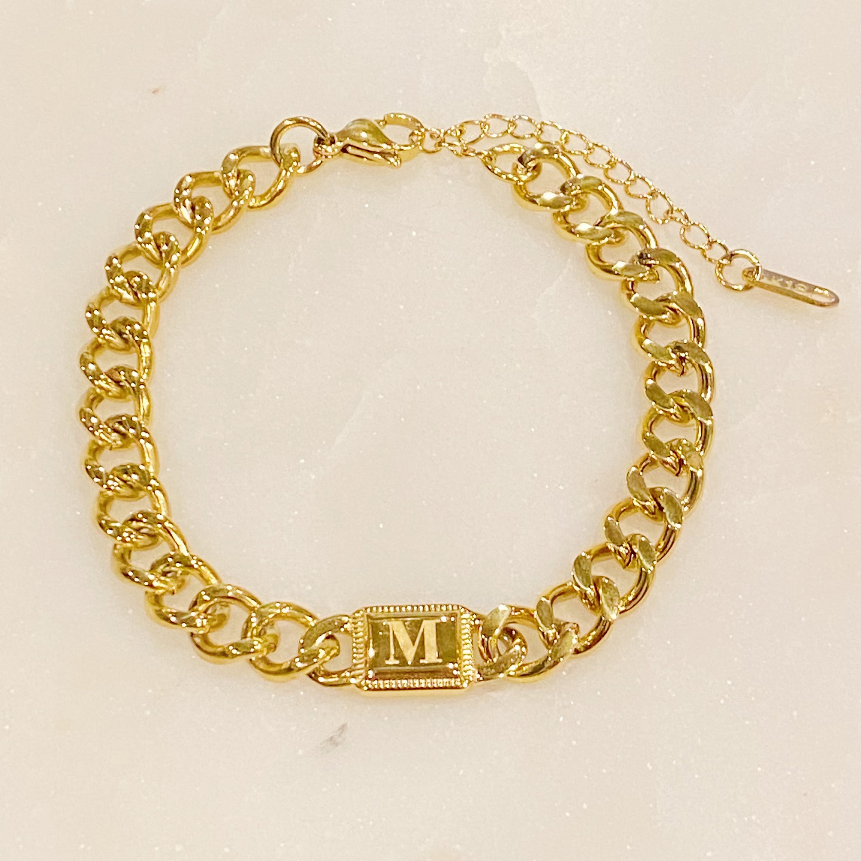 Uptown Cuban Chain Initial Bracelet featuring a personalized engraved initial tag, crafted from 18k gold plated stainless steel.