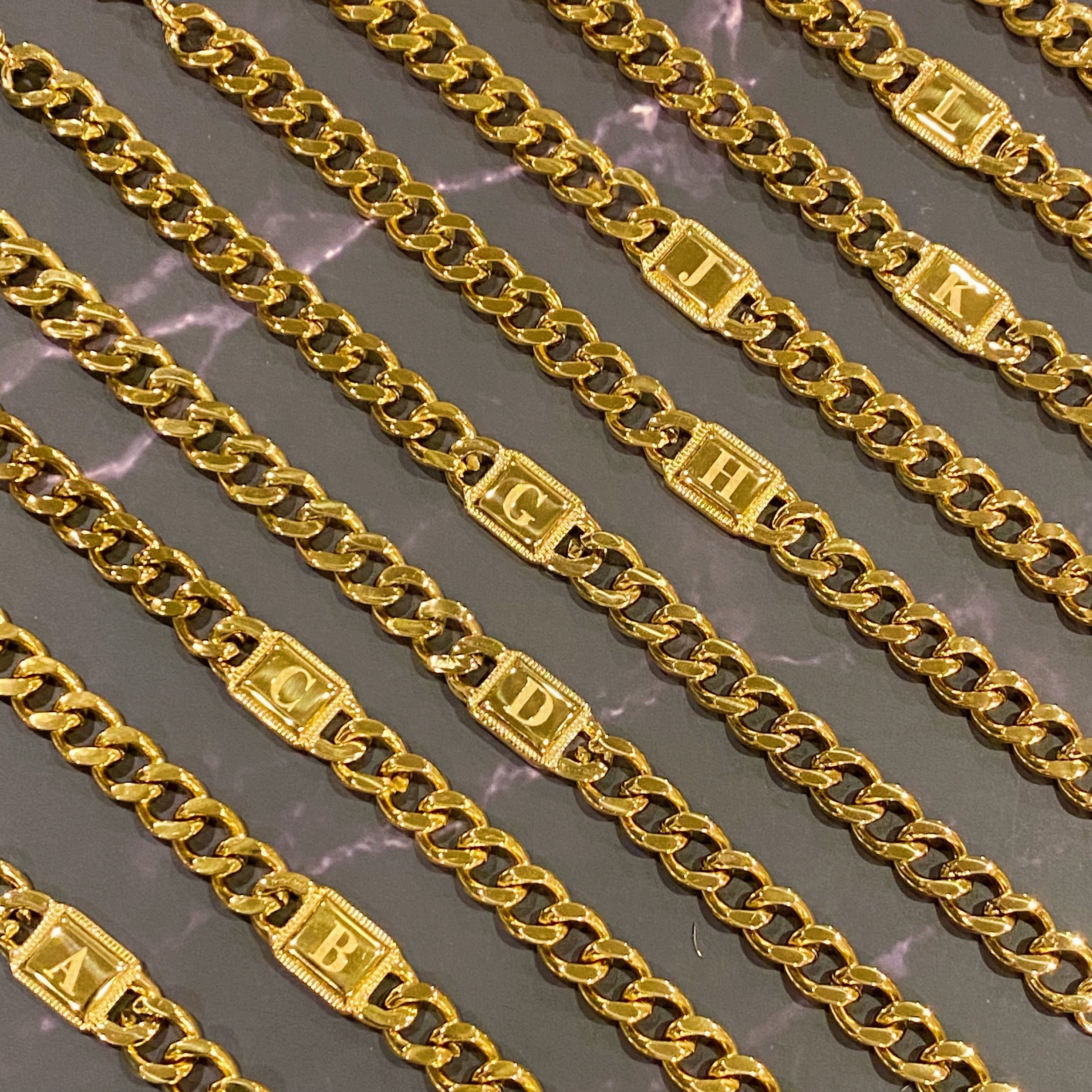 Uptown Cuban Chain Initial Bracelet featuring a personalized engraved initial tag, crafted from 18k gold plated stainless steel.