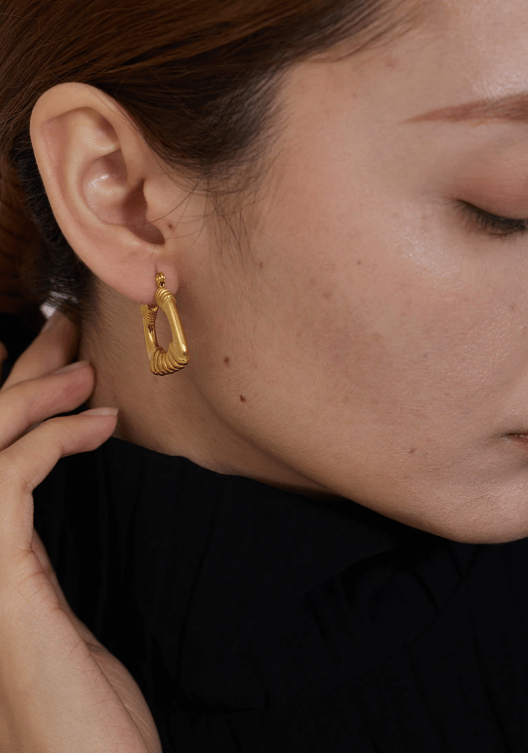 Valentina Square Statement Hoops in 18Kt yellow gold plated stainless steel, showcasing a unique square design with a textured finish.