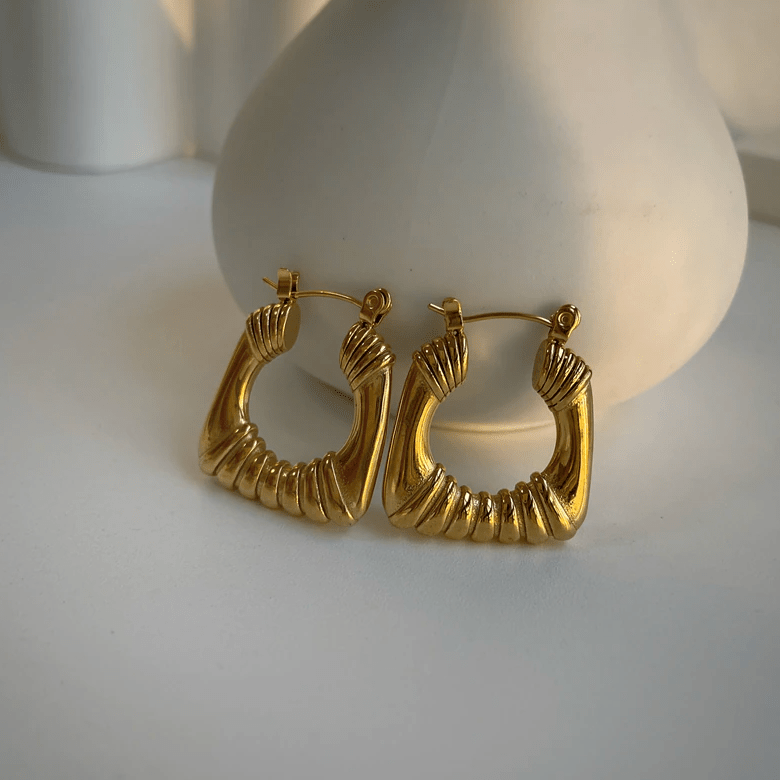 Valentina Square Statement Hoops in 18Kt yellow gold plated stainless steel, showcasing a unique square design with a textured finish.