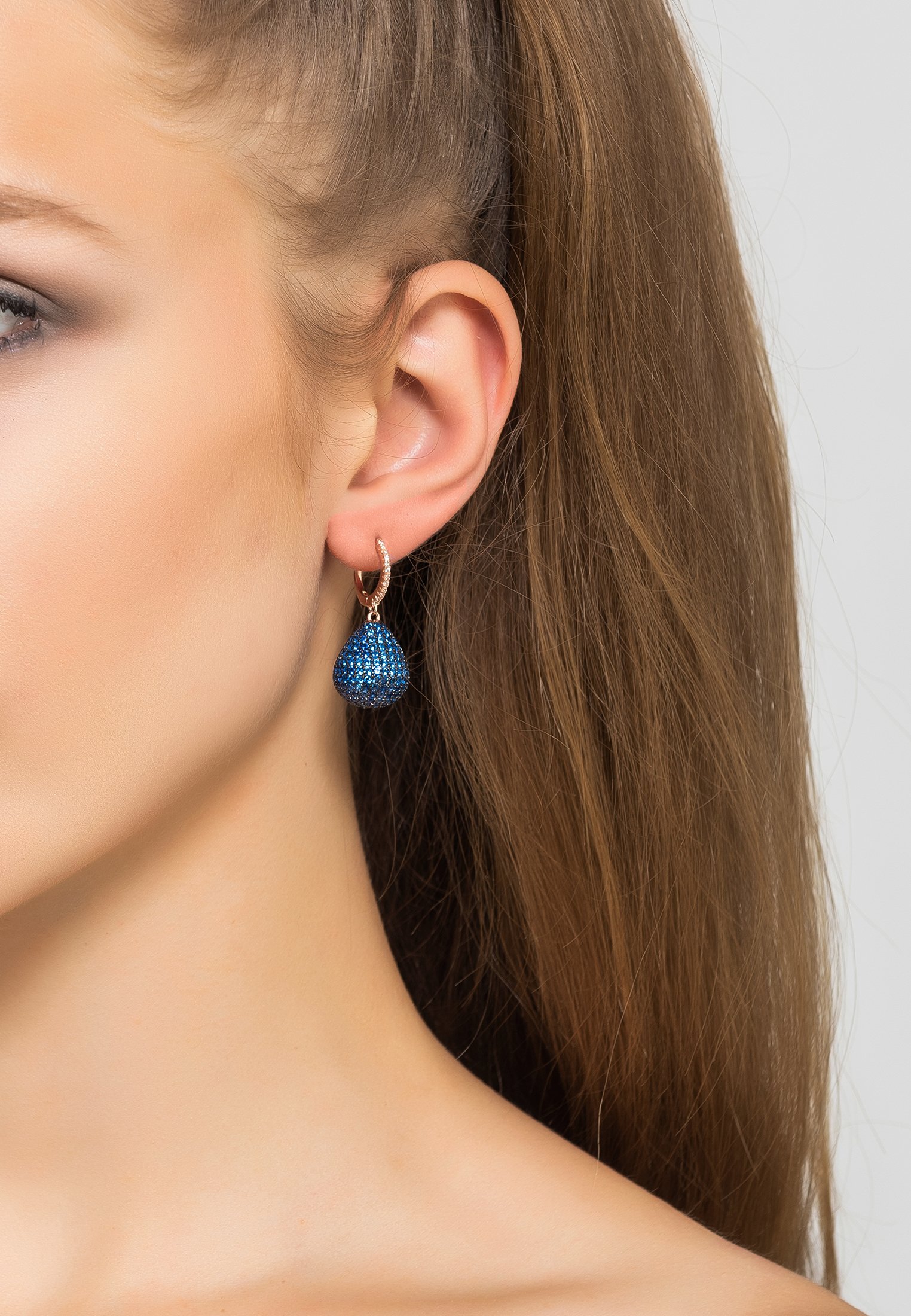 Valerie Pear Drop Gemstone Earrings featuring sapphire blue zirconia set in sterling silver, elegantly designed for statement wear.