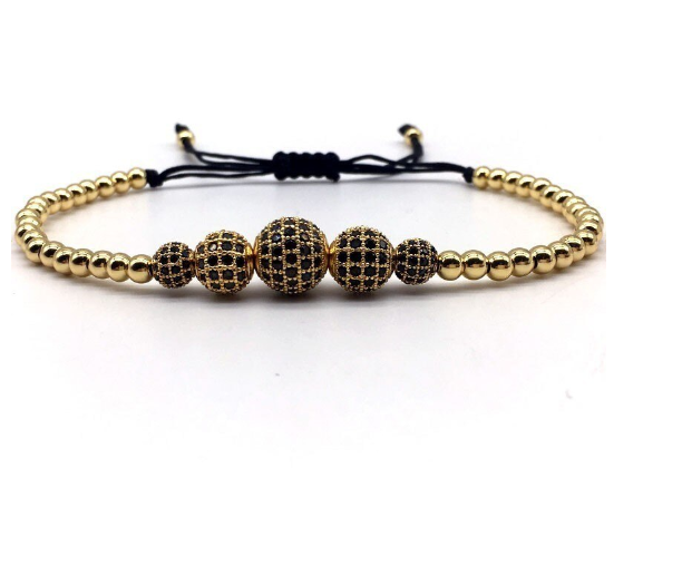 Gold beaded bracelet with pattern.