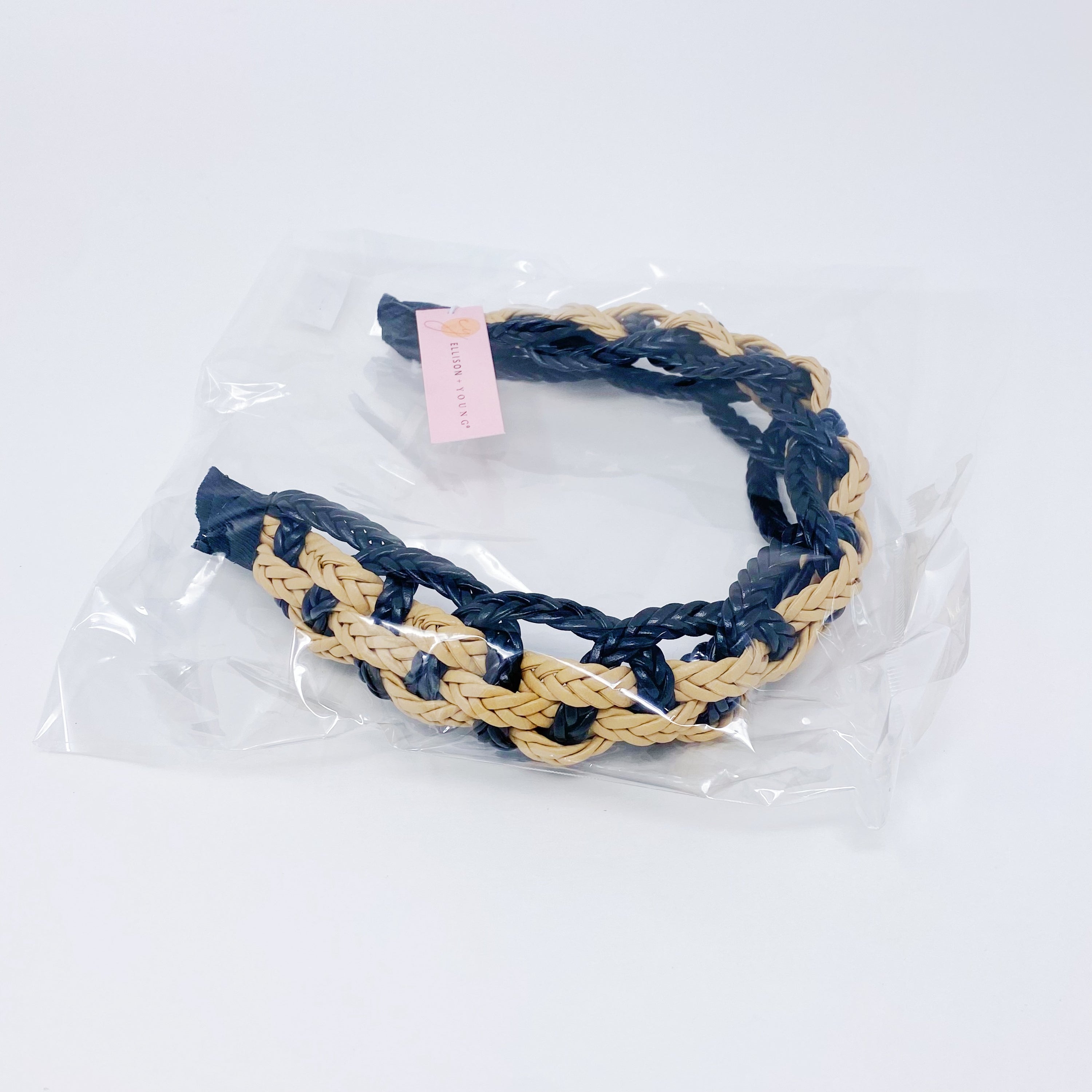 A stylish vegan leather braided headband with soft edges, perfect for enhancing any outfit.