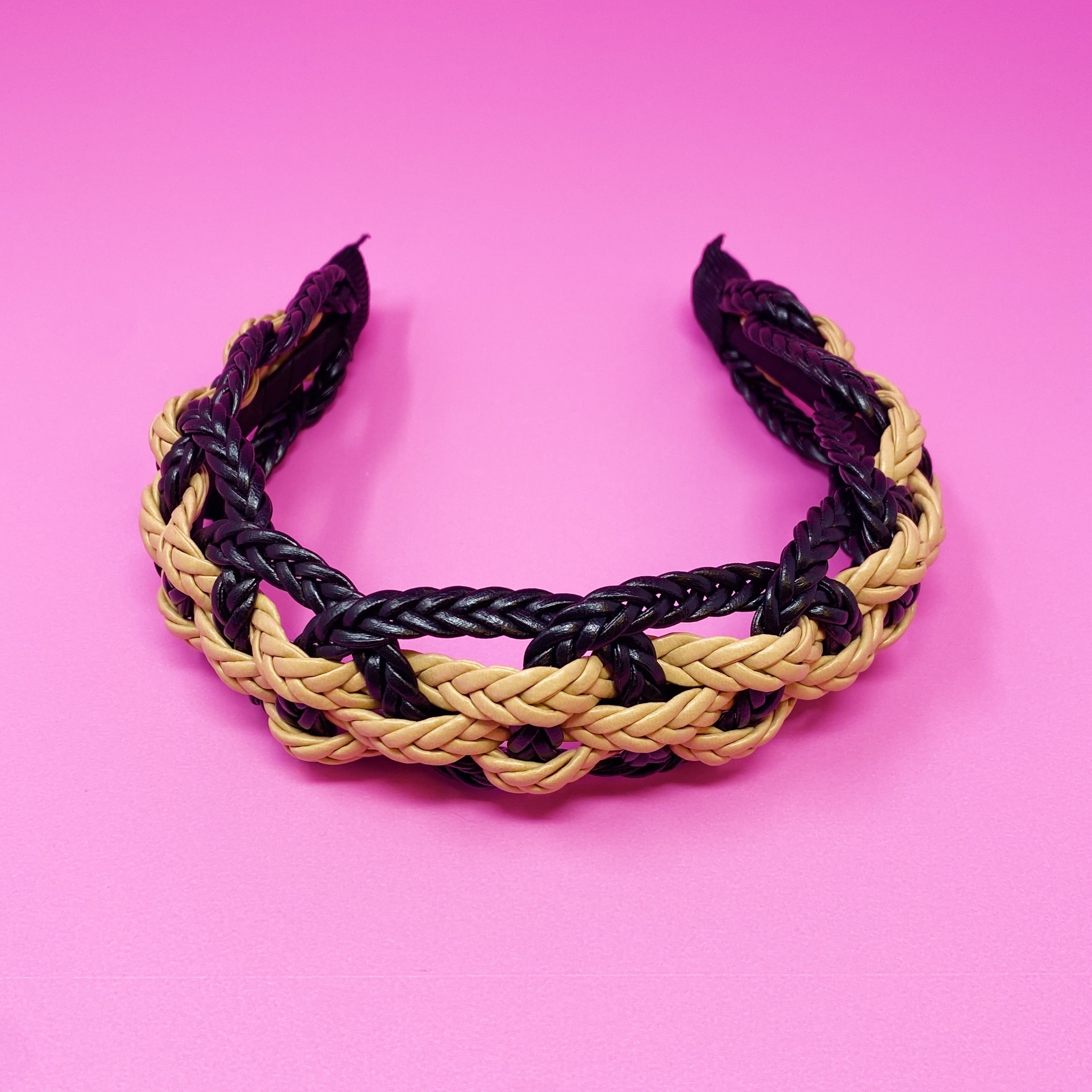 A stylish vegan leather braided headband with soft edges, perfect for enhancing any outfit.