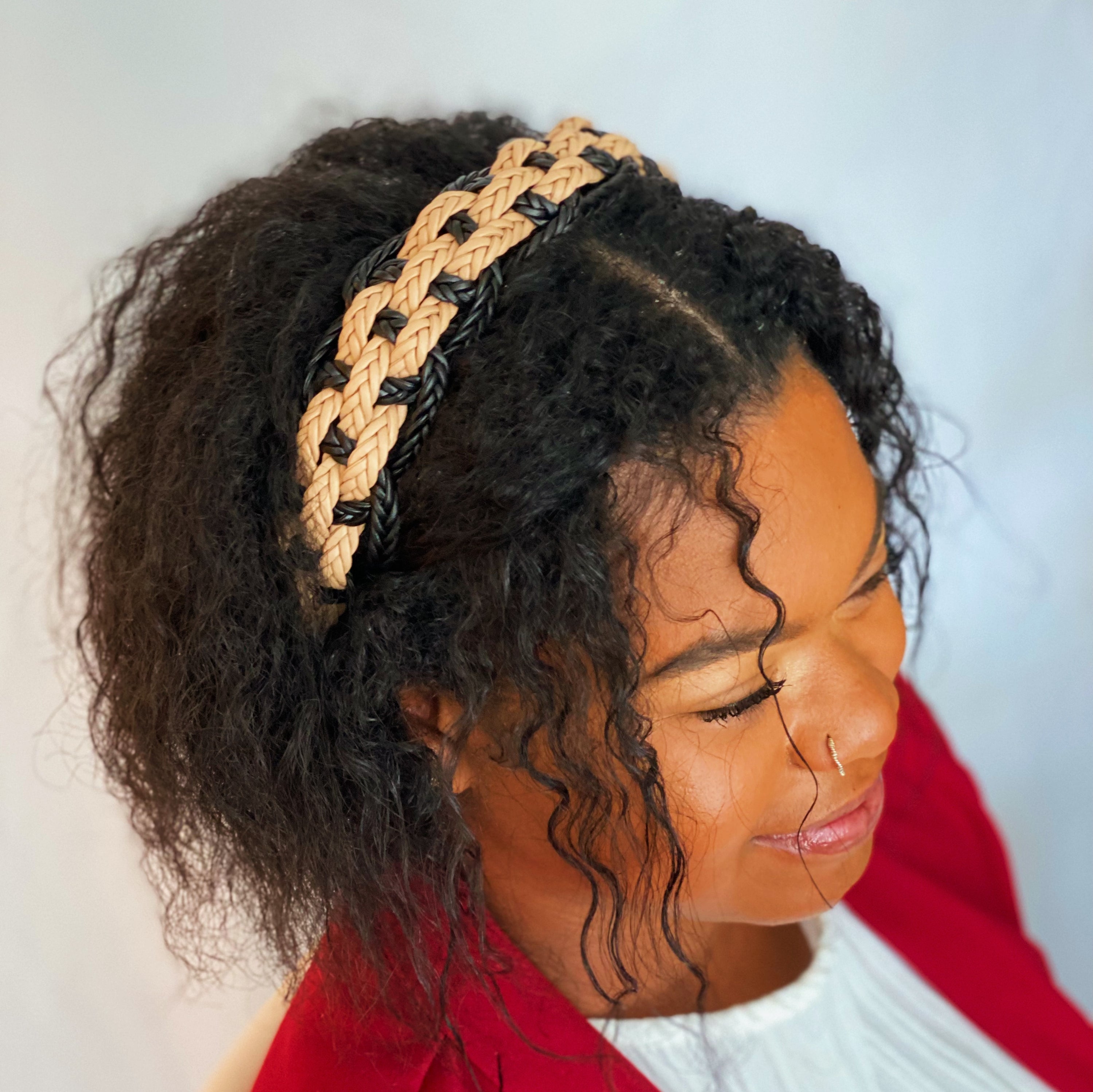 A stylish vegan leather braided headband with soft edges, perfect for enhancing any outfit.