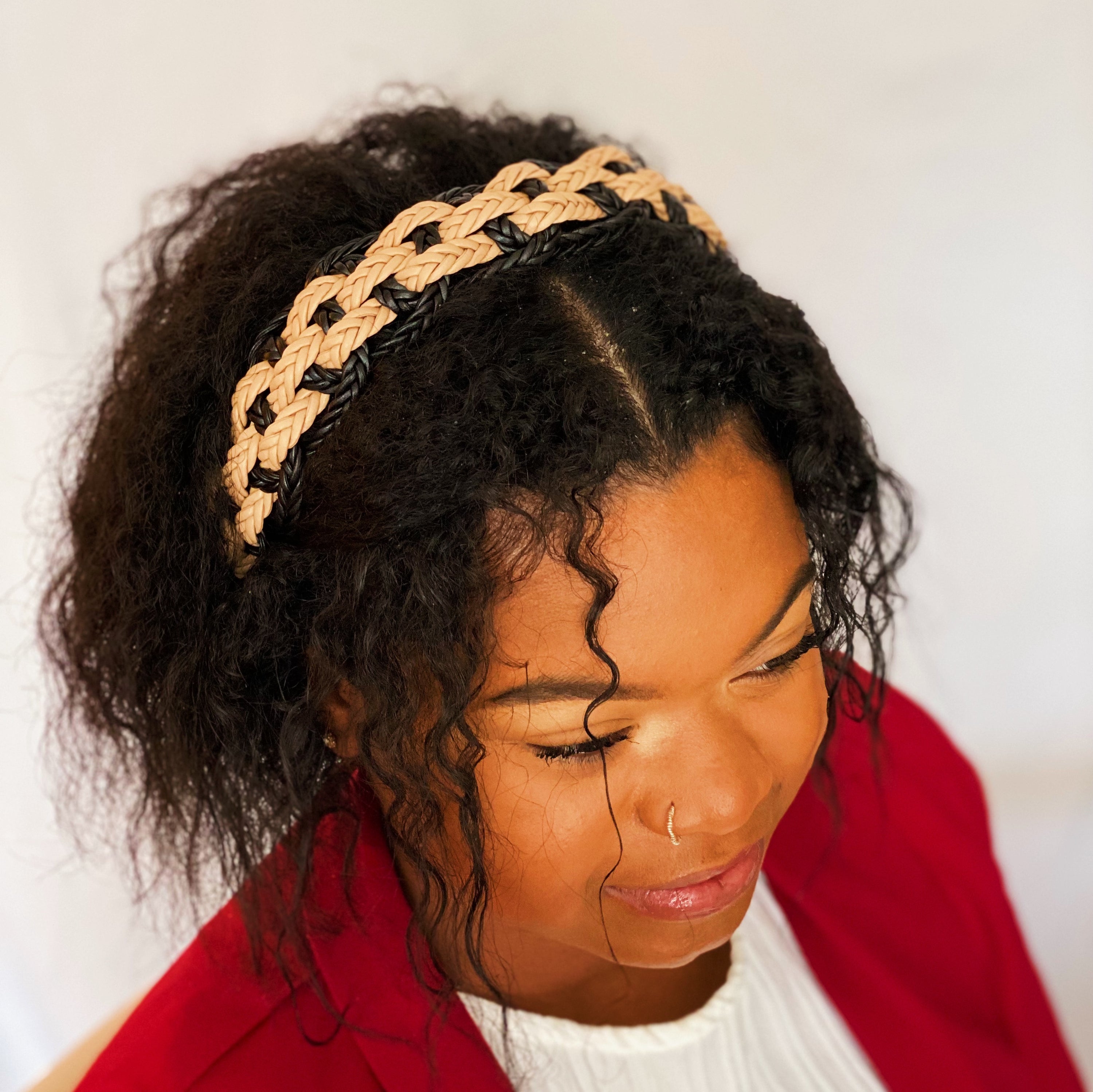 A stylish vegan leather braided headband with soft edges, perfect for enhancing any outfit.