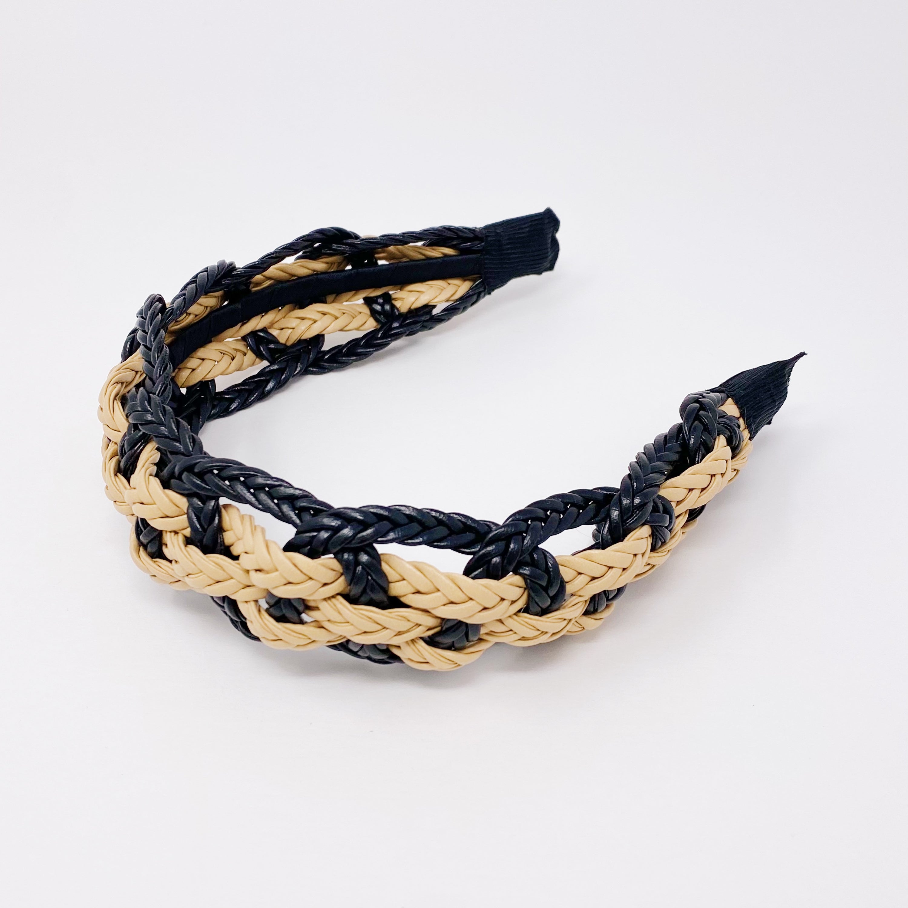 A stylish vegan leather braided headband with soft edges, perfect for enhancing any outfit.