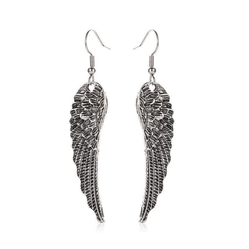 A pair of vintage angle's wing earrings made from alloy, showcasing intricate wing designs.