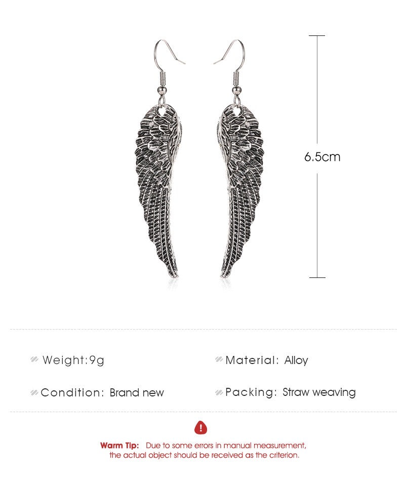 A pair of vintage angle's wing earrings made from alloy, showcasing intricate wing designs.