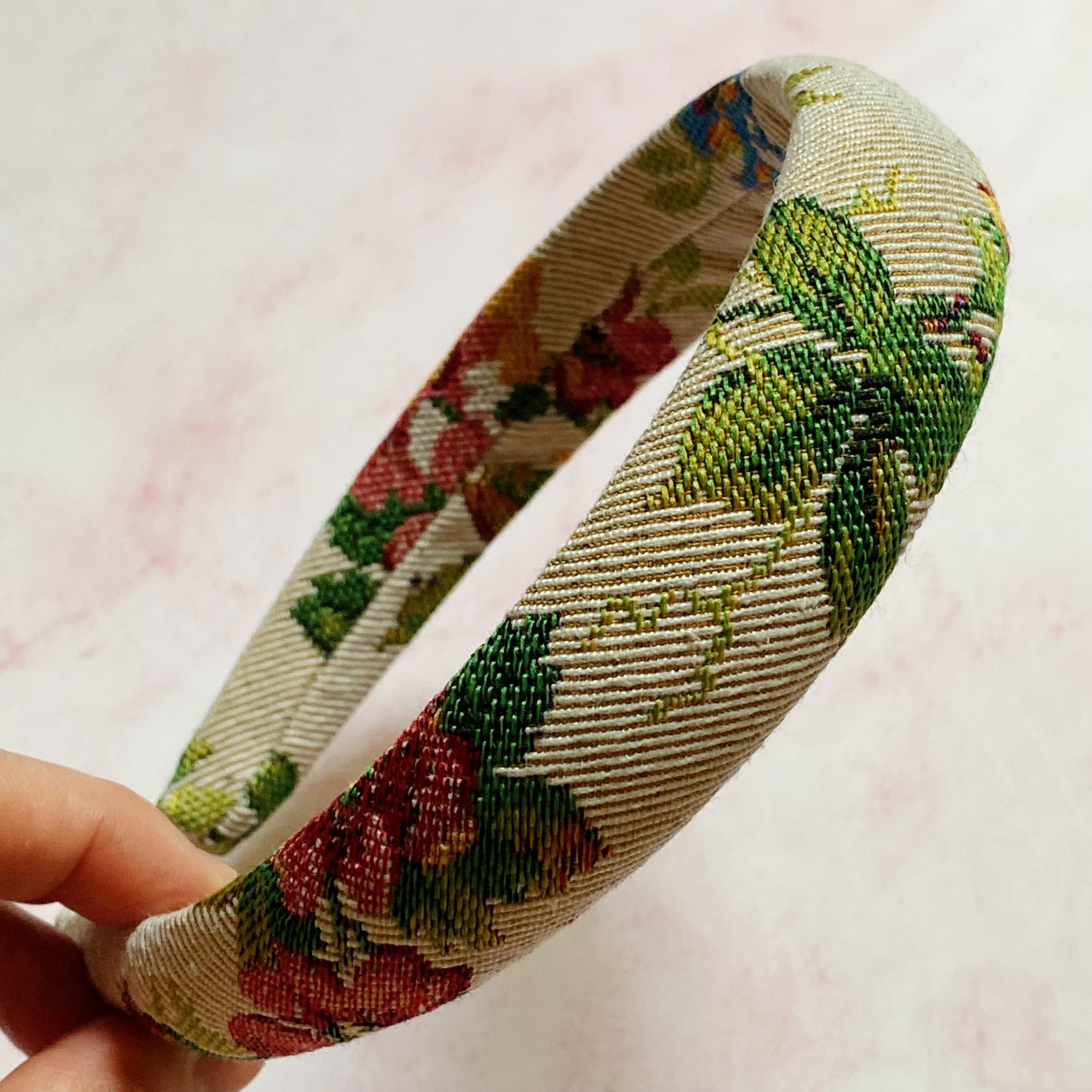 A beautifully crafted Vintage Garden Floral Headband featuring a retro tapestry flower pattern with soft edges for comfort.