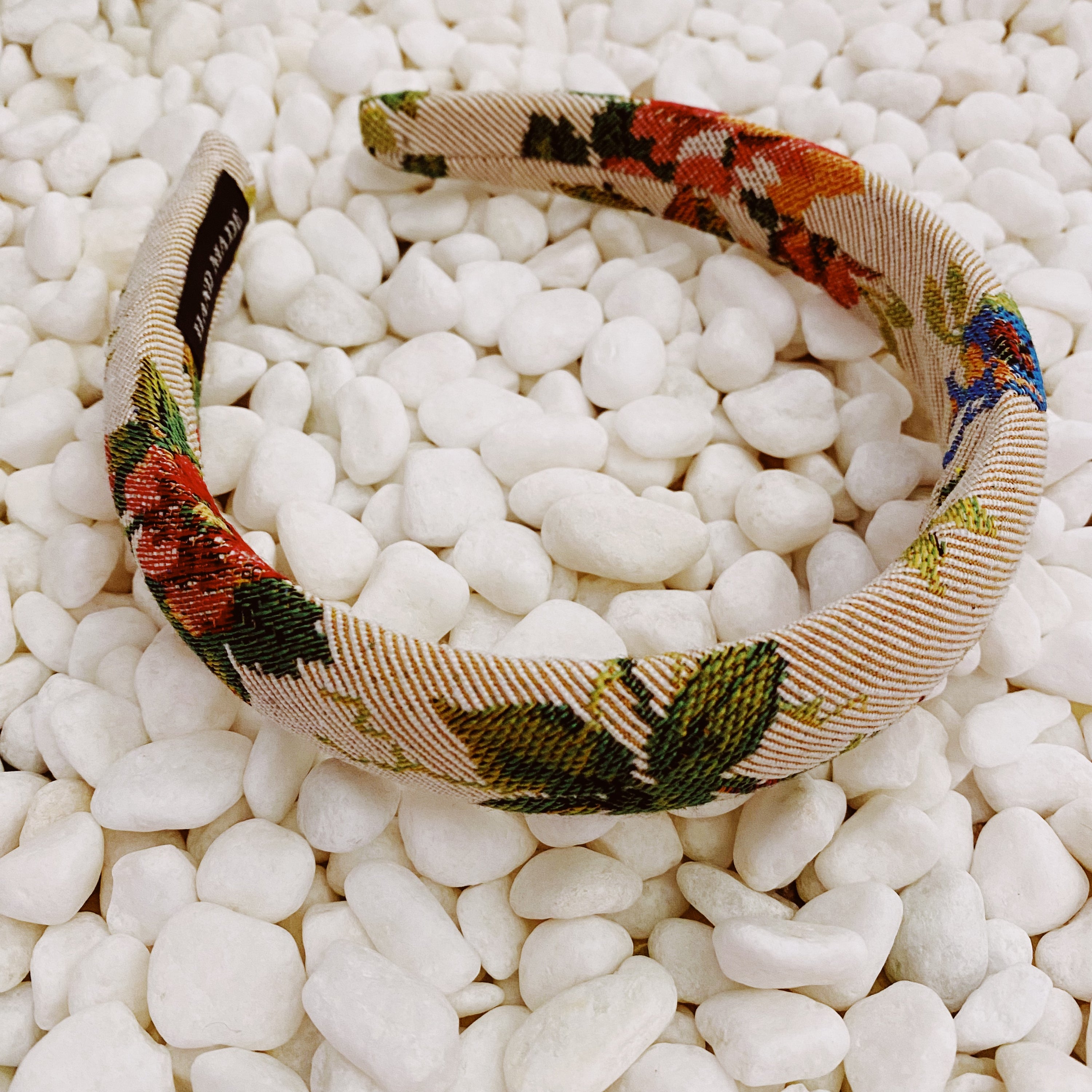 A beautifully crafted Vintage Garden Floral Headband featuring a retro tapestry flower pattern with soft edges for comfort.