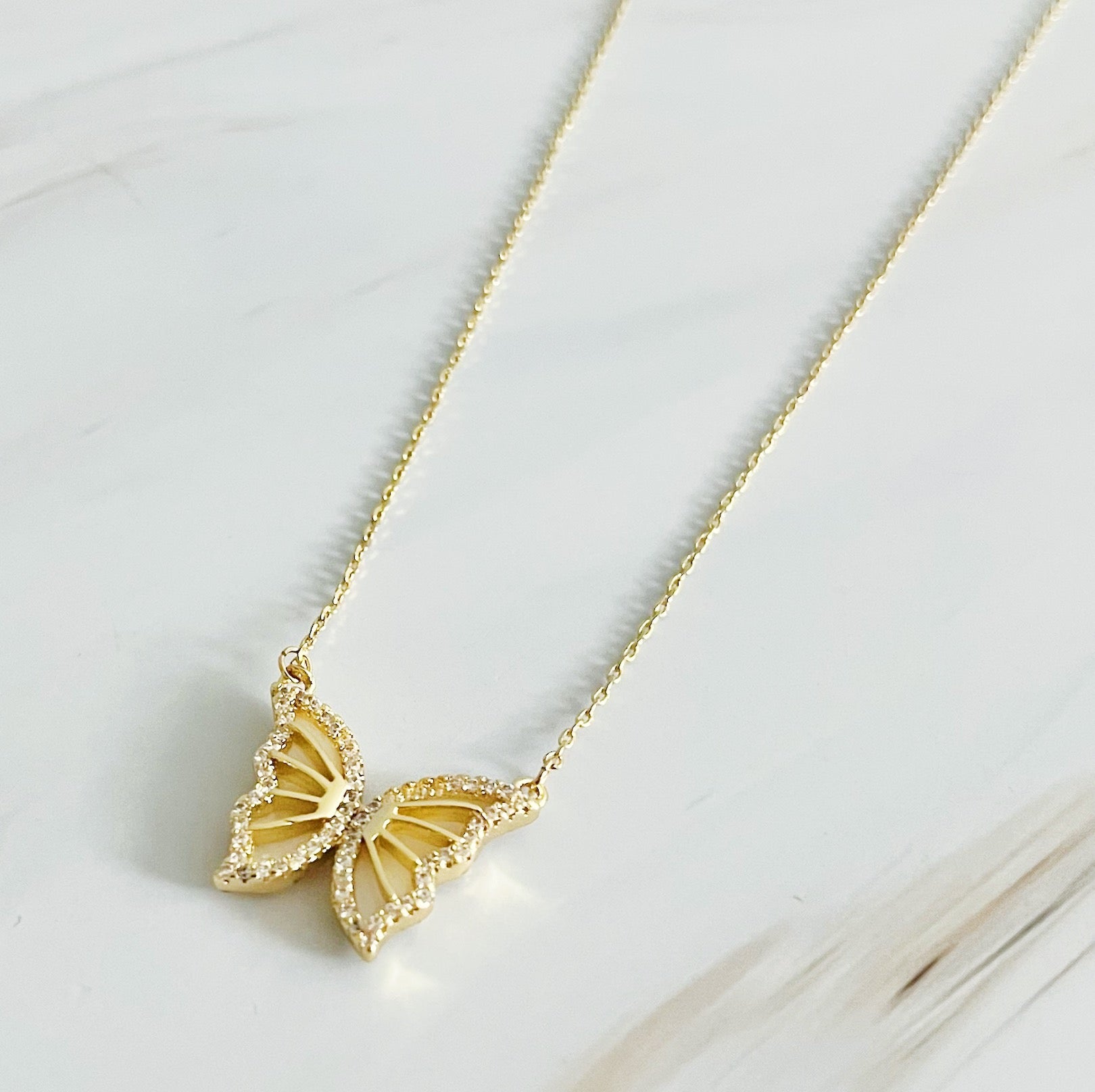 Vintage Glam Reversible Butterfly Necklace featuring an intricate butterfly pendant, 18k gold plated chain, and adjustable length.