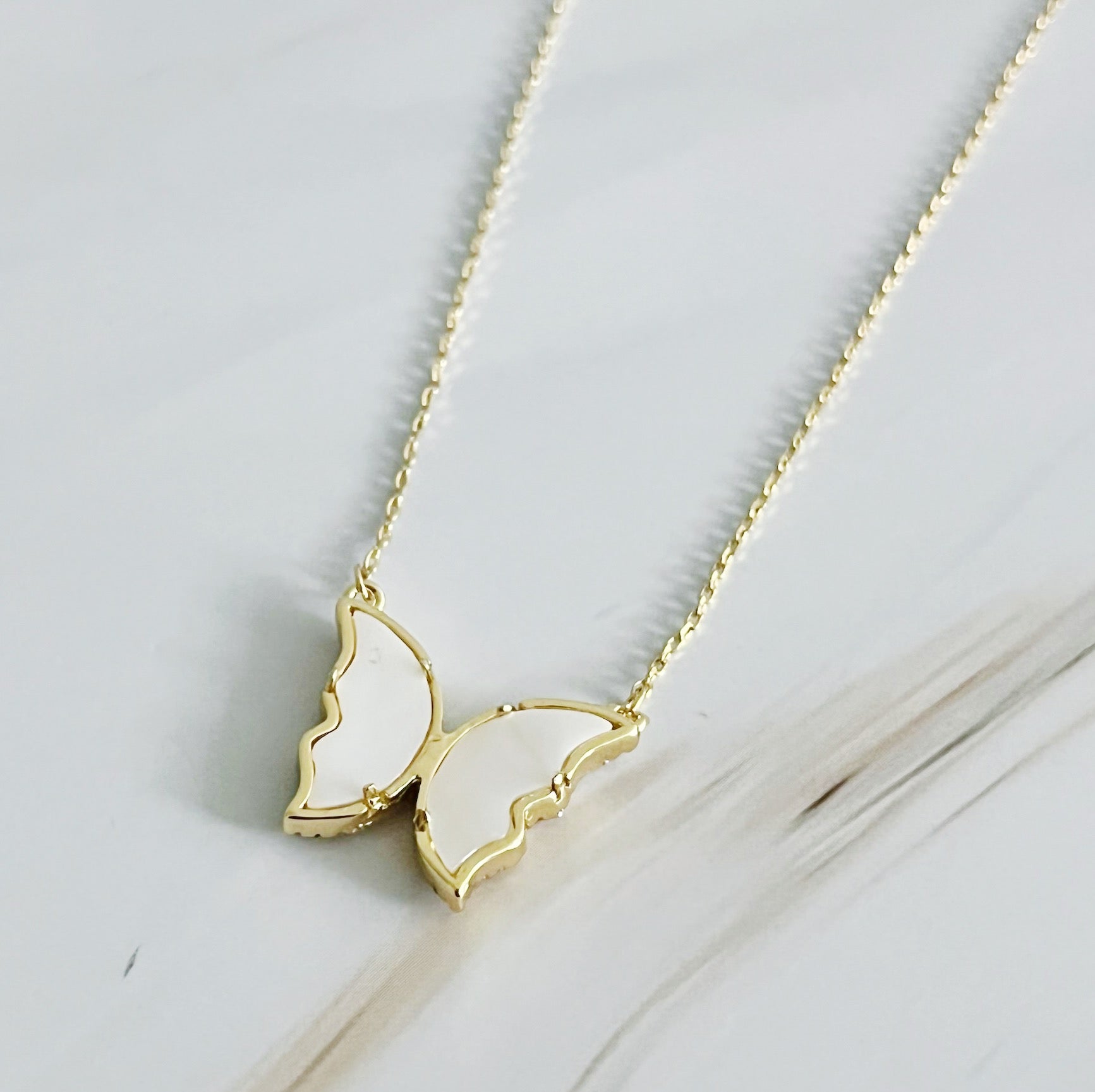 Vintage Glam Reversible Butterfly Necklace featuring an intricate butterfly pendant, 18k gold plated chain, and adjustable length.