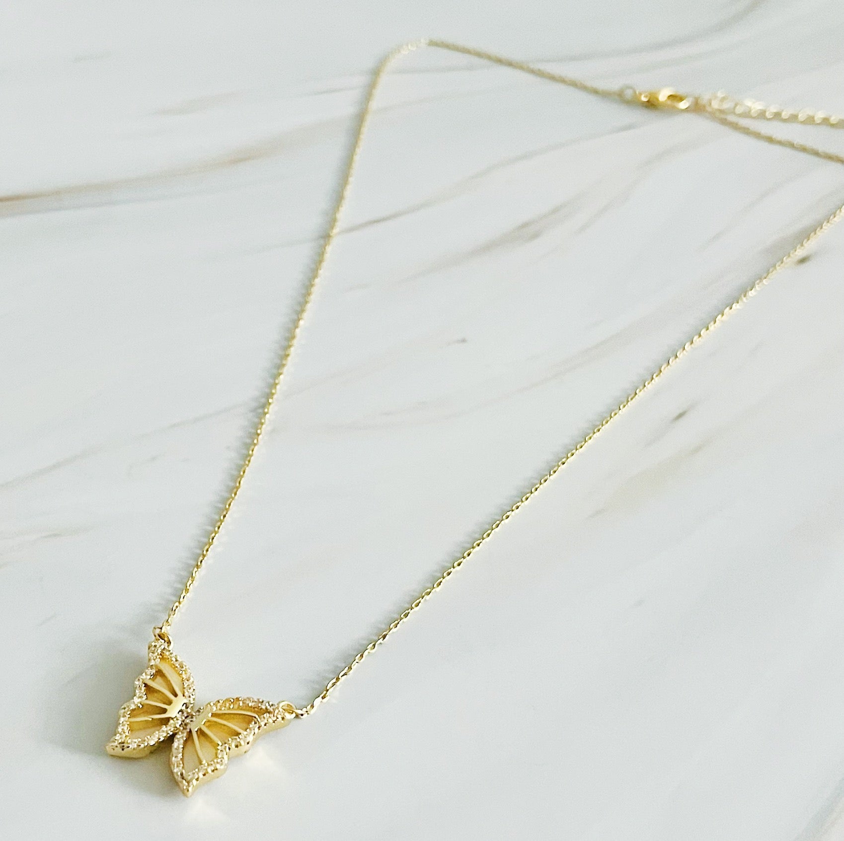 Vintage Glam Reversible Butterfly Necklace featuring an intricate butterfly pendant, 18k gold plated chain, and adjustable length.