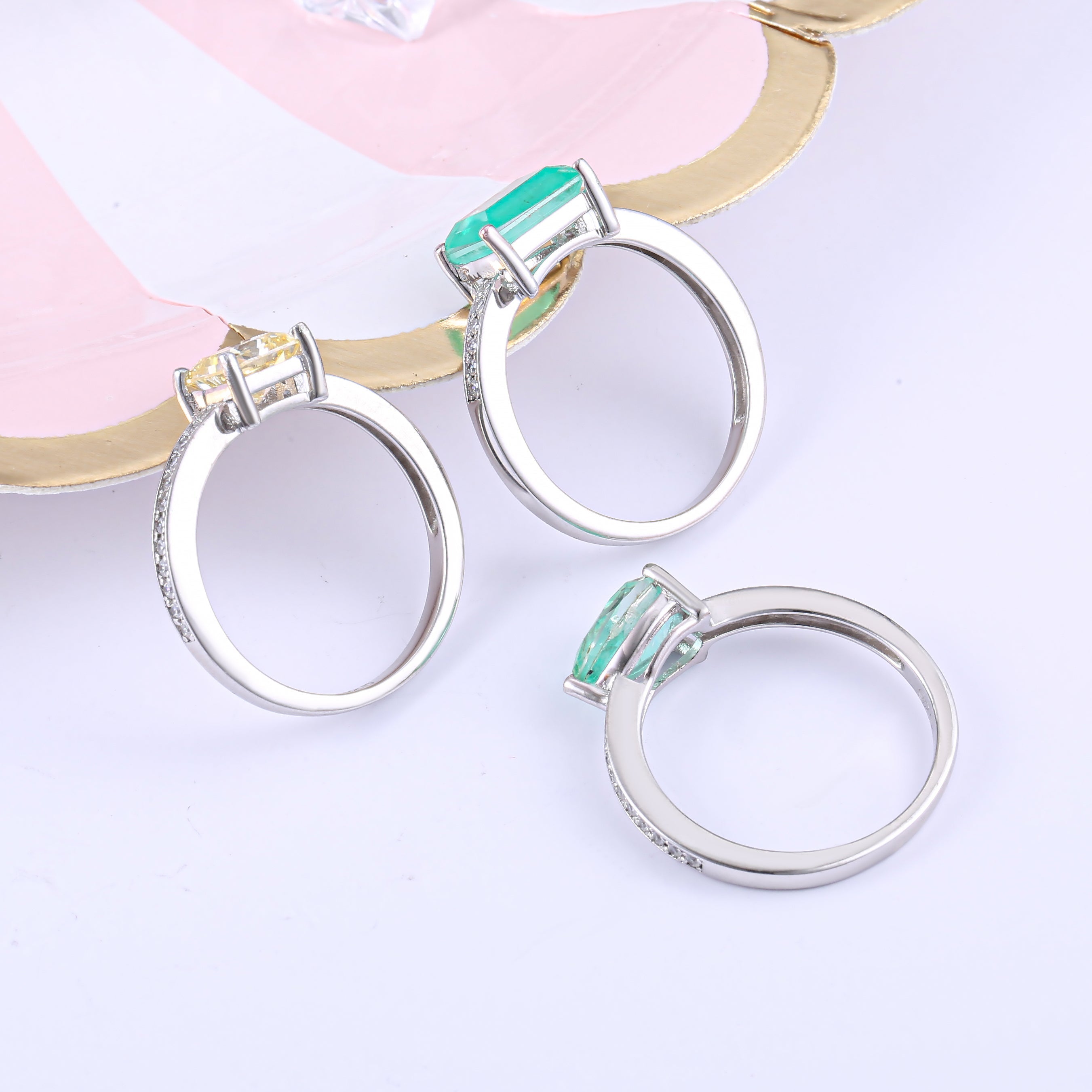 A collection of vintage stackable engagement rings made from sterling silver and white gold, featuring white sapphire stones.