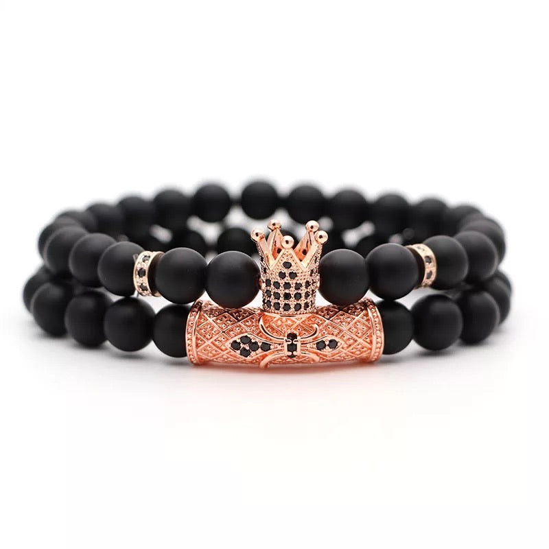 Vortex Bracelet Set featuring two black onyx bracelets with zirconia spacers and royal crown beads, available in four metal colors.