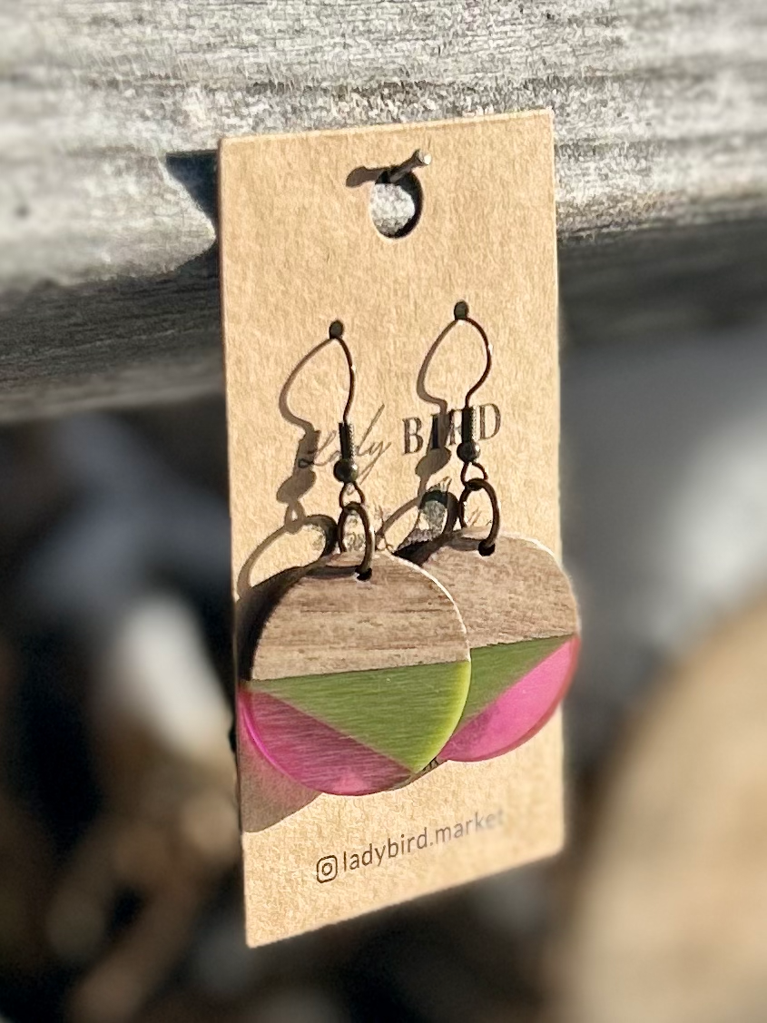 Walnut wood circle earrings with army green and purple resin stripes, showcasing a unique and earthy design.