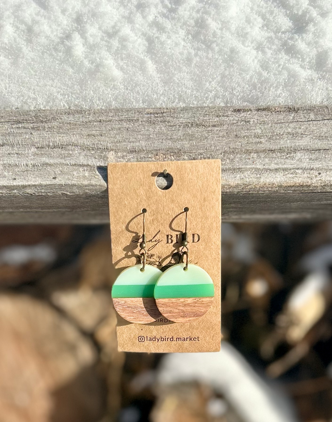 A pair of Walnut Wood and Lime Green Striped Resin Circle Earrings showcasing unique wood grain and vibrant green stripes.