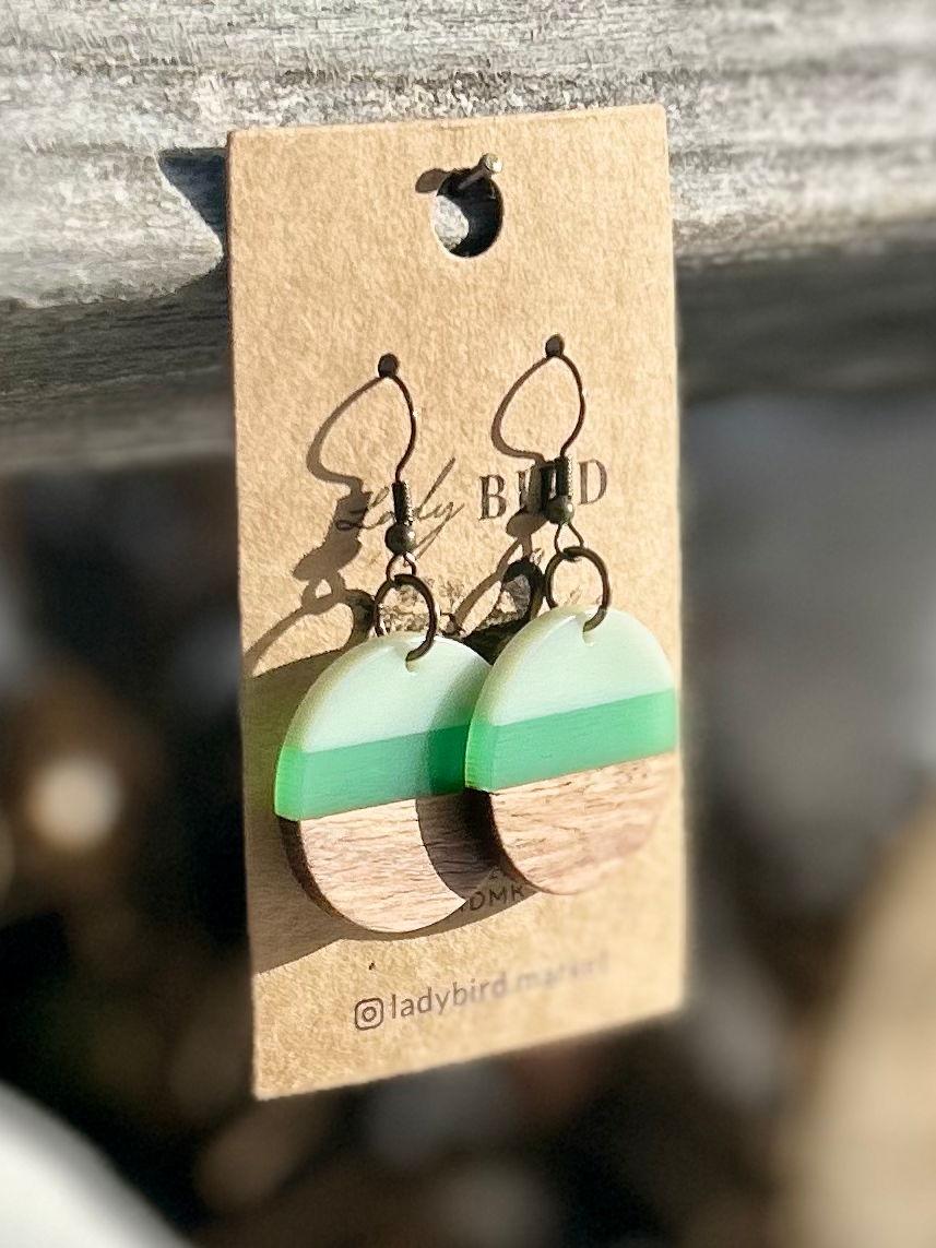 A pair of Walnut Wood and Lime Green Striped Resin Circle Earrings showcasing unique wood grain and vibrant green stripes.