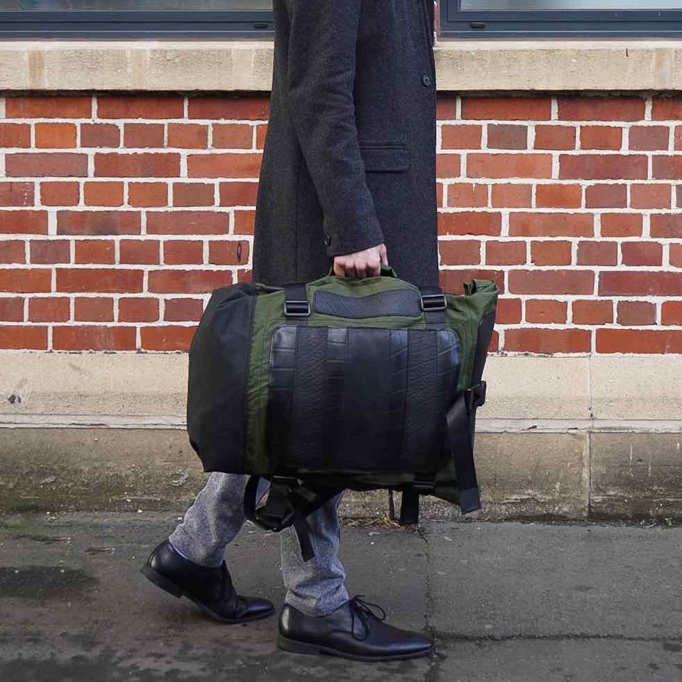 Water Resistant Roll Top Vegan Backpack made from recycled materials, featuring a roll-top closure and padded laptop compartment.