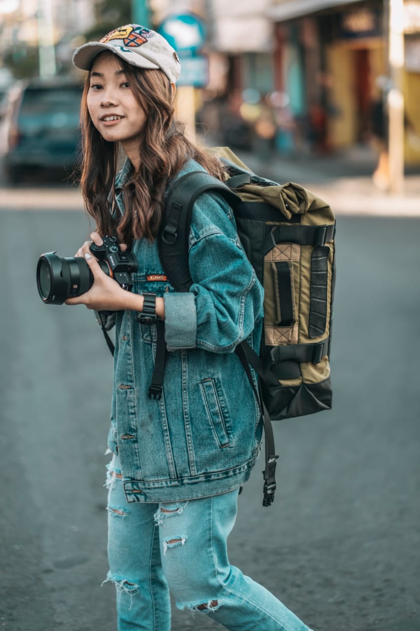 Water Resistant Roll Top Vegan Backpack made from recycled materials, featuring a roll-top closure and padded laptop compartment.