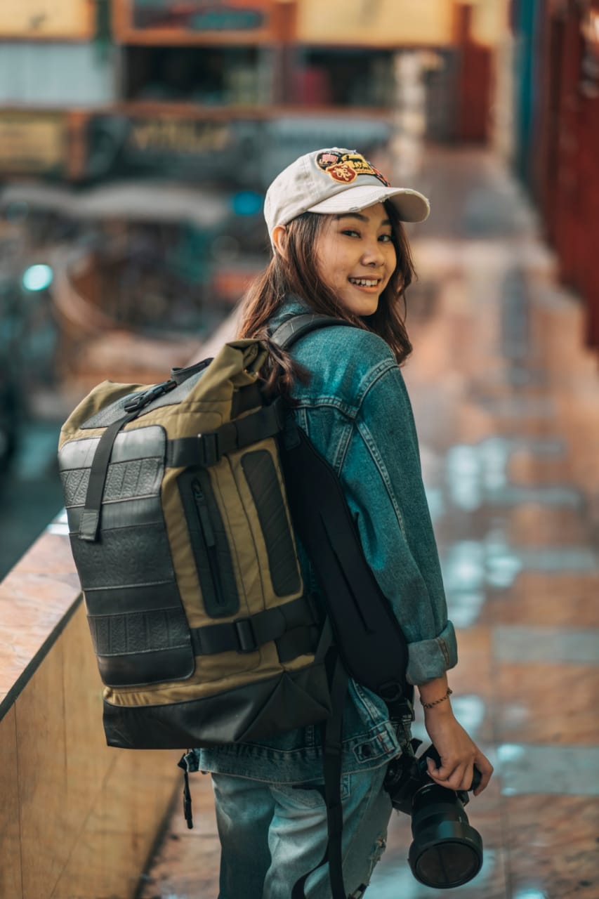 Water Resistant Roll Top Vegan Backpack made from recycled materials, featuring a roll-top closure and padded laptop compartment.