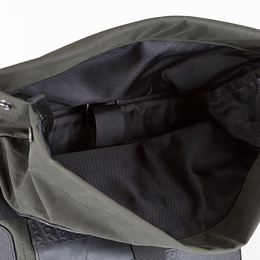 Water Resistant Roll Top Vegan Backpack made from recycled materials, featuring a roll-top closure and padded laptop compartment.