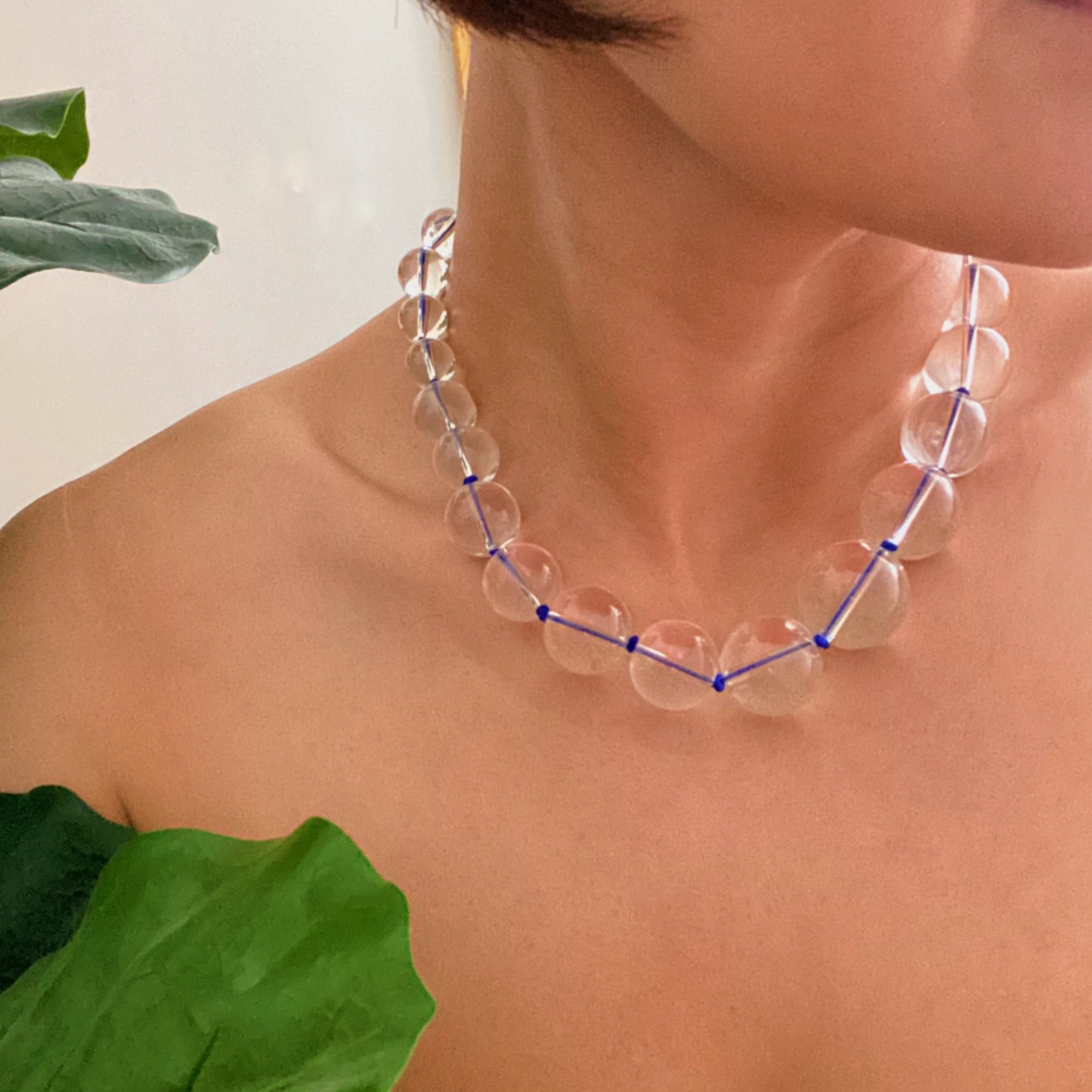 A vibrant Water Stone Knotted In Color Necklace featuring graduated clear ball beads and colorful hand-knotted threads, perfect for any occasion.