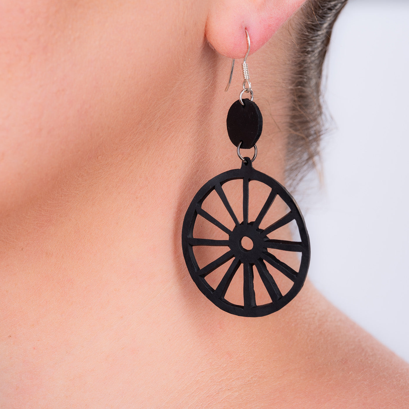 A pair of Water Wheel Upcycled Rubber Earrings showcasing intricate detailing and unique patterns, handcrafted from recycled inner tubes.