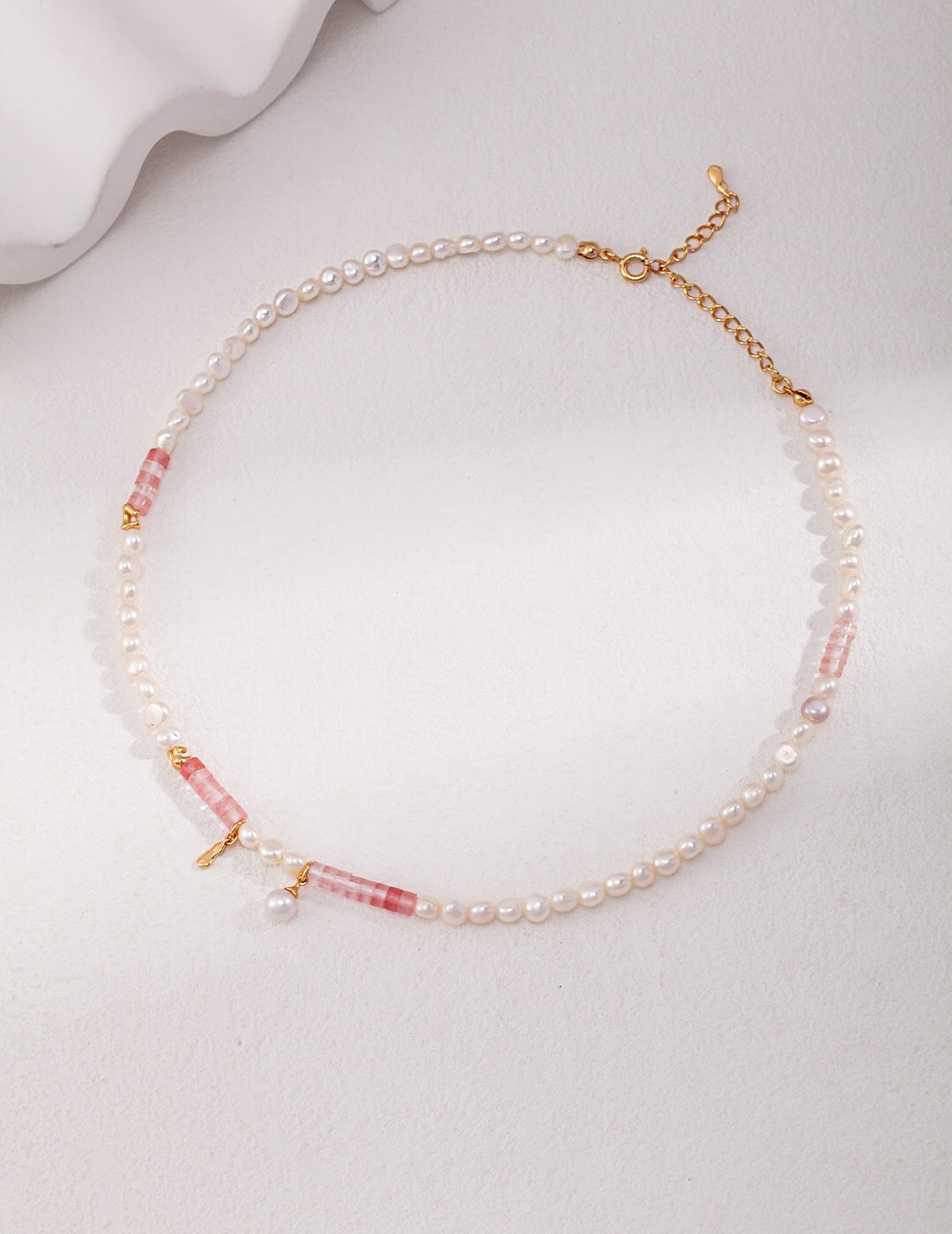 A stunning Watermelon Ruby Freshwater Pearl Necklace featuring natural pearls and gold vermeil, elegantly displayed on a soft background.