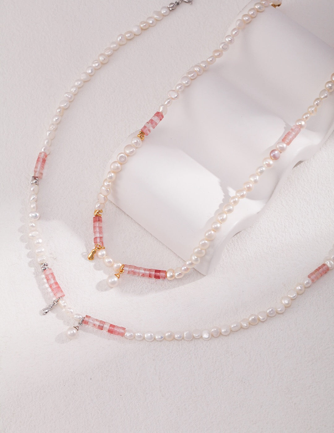 A stunning Watermelon Ruby Freshwater Pearl Necklace featuring natural pearls and gold vermeil, elegantly displayed on a soft background.