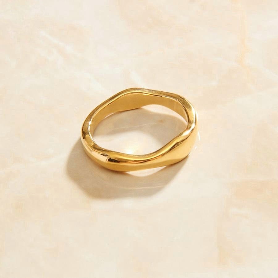 A beautiful Wave Layering Stacking Ring made of titanium steel with 18k gold plating, showcasing its elegant design and shiny finish.