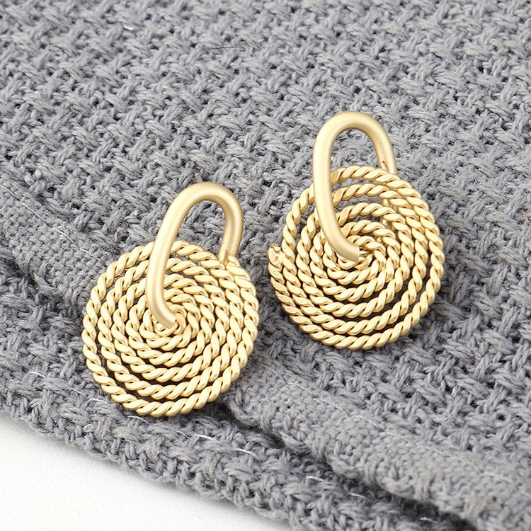 A pair of elegant Weaving Disc Earrings made from brass and s925 silver, featuring a unique weaving pattern.