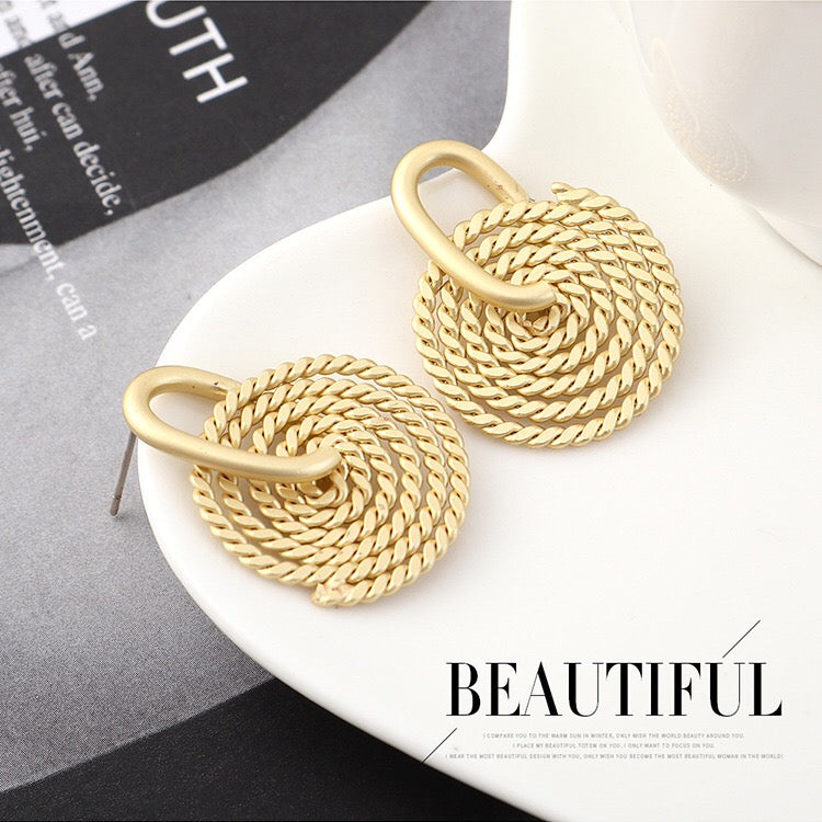 A pair of elegant Weaving Disc Earrings made from brass and s925 silver, featuring a unique weaving pattern.