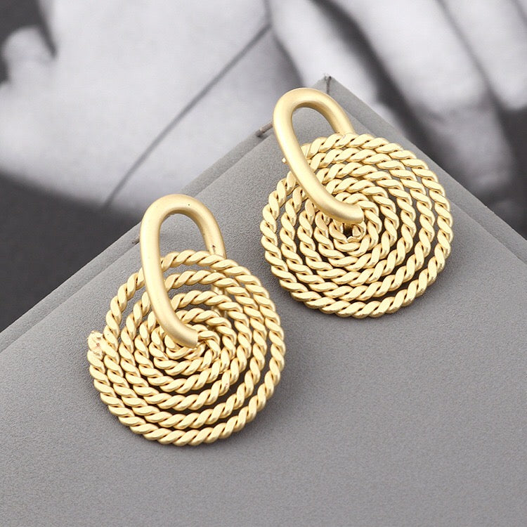 A pair of elegant Weaving Disc Earrings made from brass and s925 silver, featuring a unique weaving pattern.