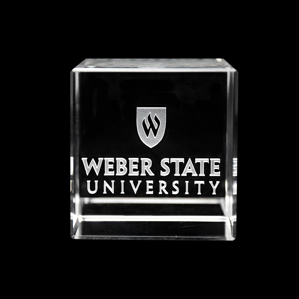 Weber State University Logo Cube made of optical crystal, featuring the Weber State logo inside, showcasing sharp cut angles and vibrant reflections.