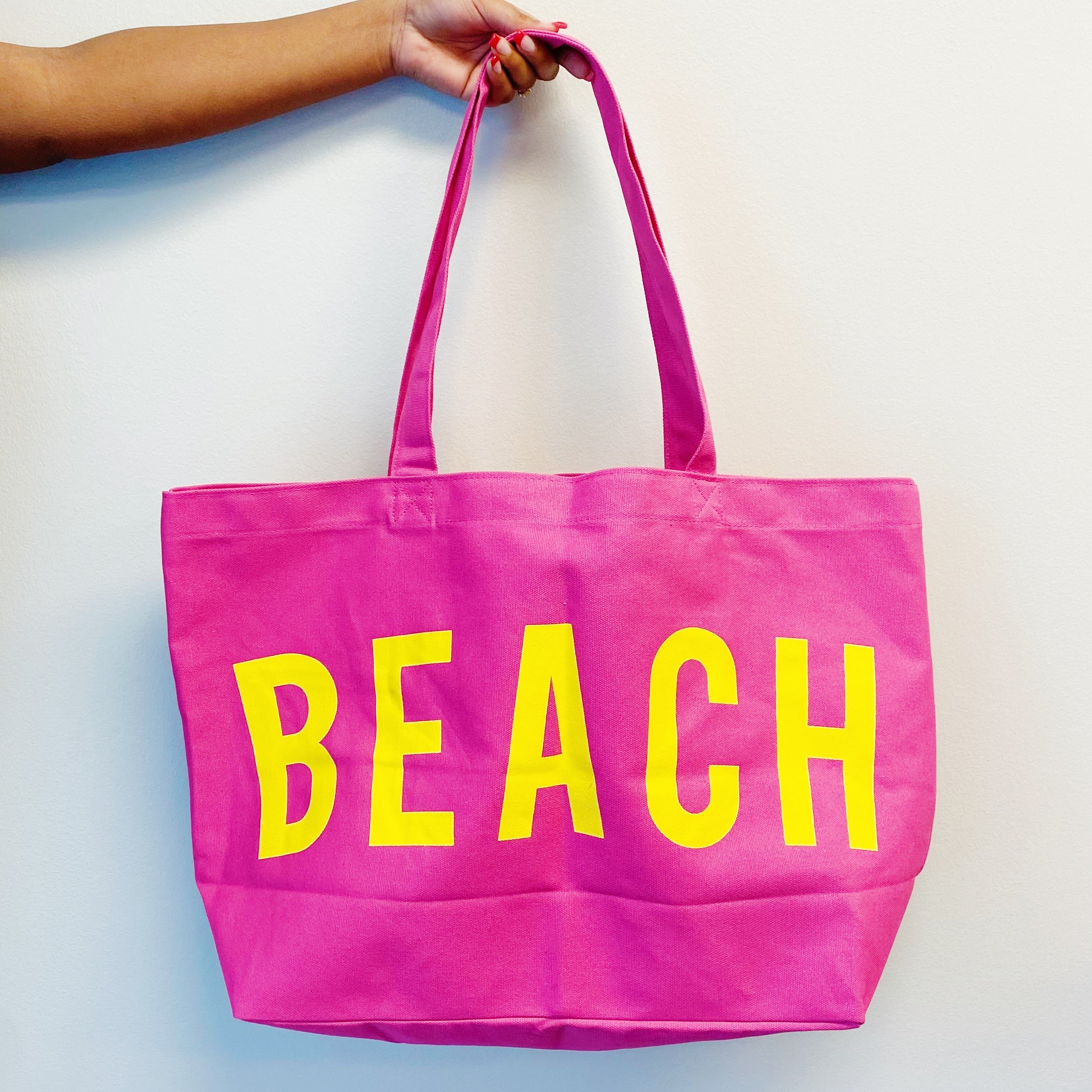 Well Made Beach Canvas Tote in vibrant colors with large pockets, perfect for beach outings.