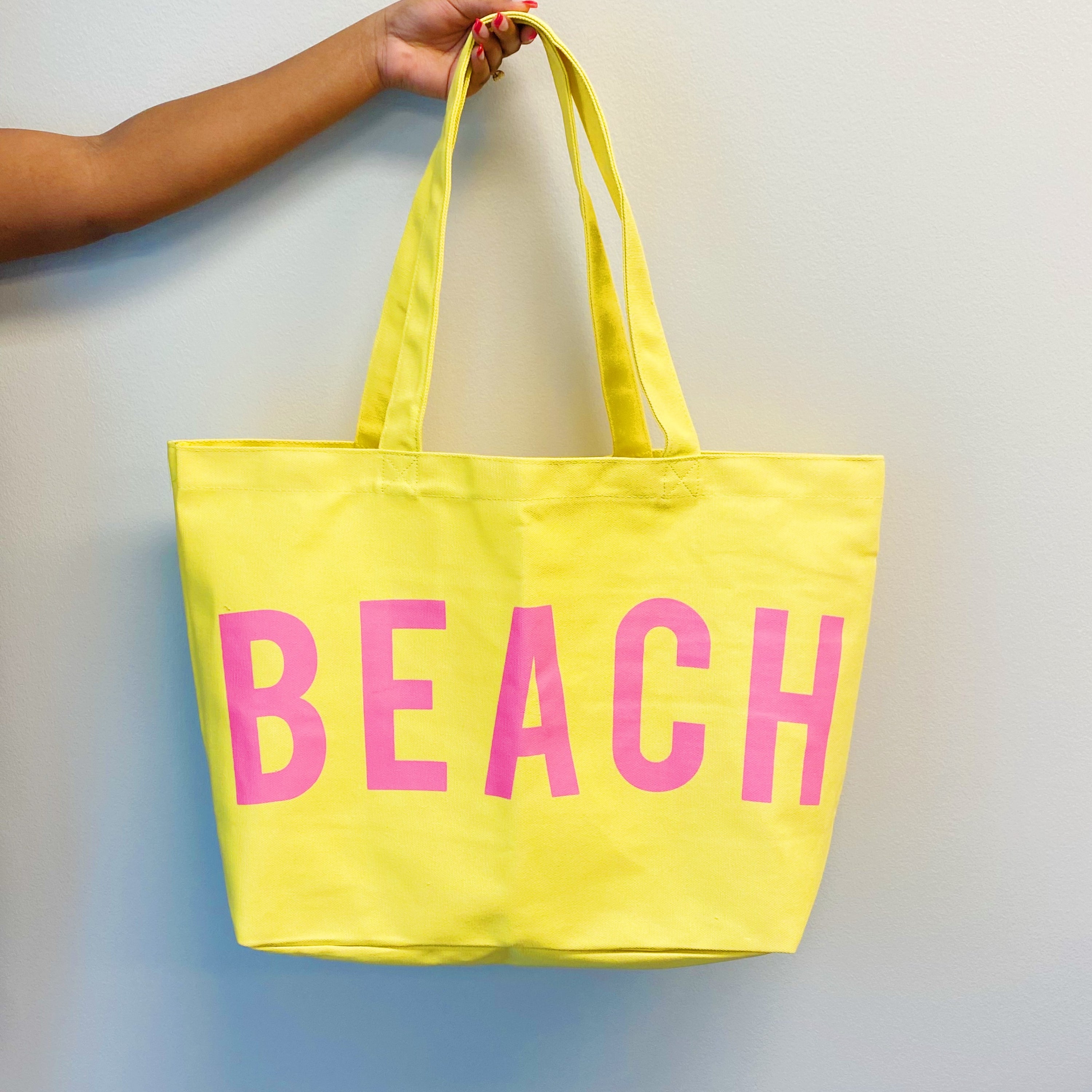 Well Made Beach Canvas Tote in vibrant colors with large pockets, perfect for beach outings.