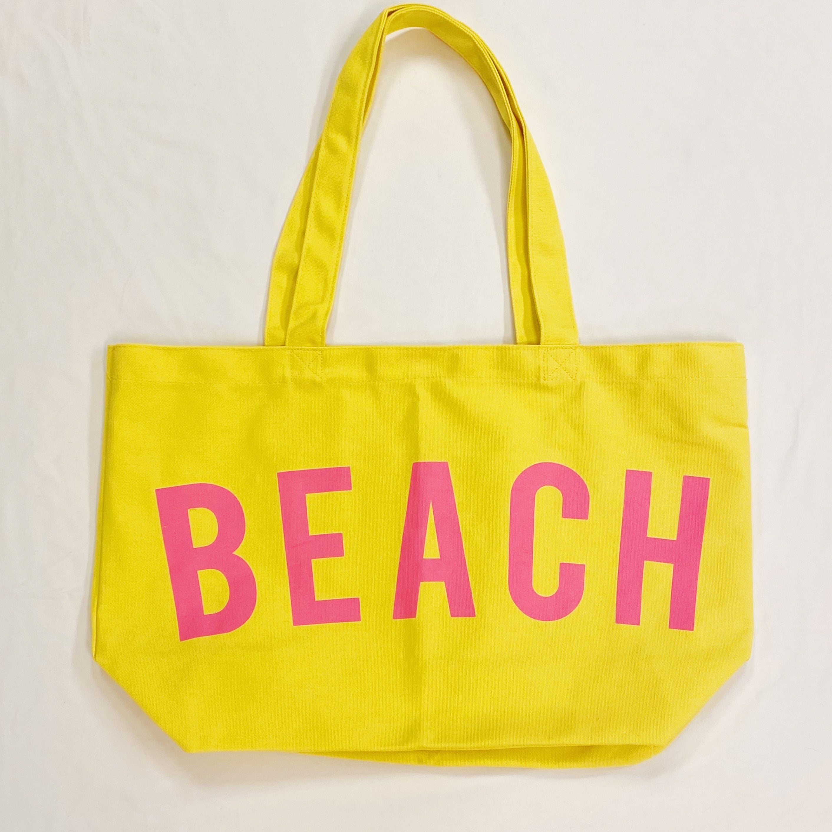 Well Made Beach Canvas Tote in vibrant colors with large pockets, perfect for beach outings.