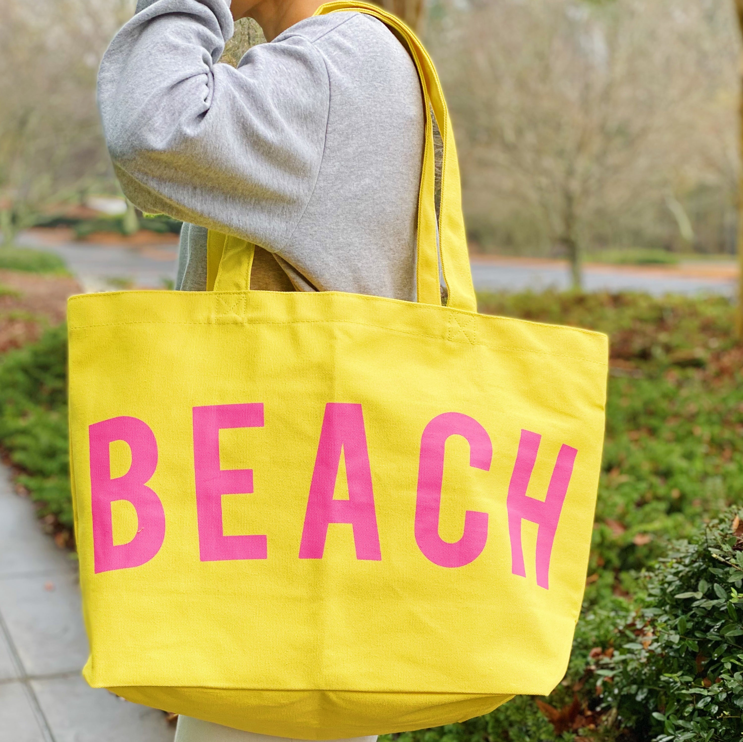 Well Made Beach Canvas Tote in vibrant colors with large pockets, perfect for beach outings.